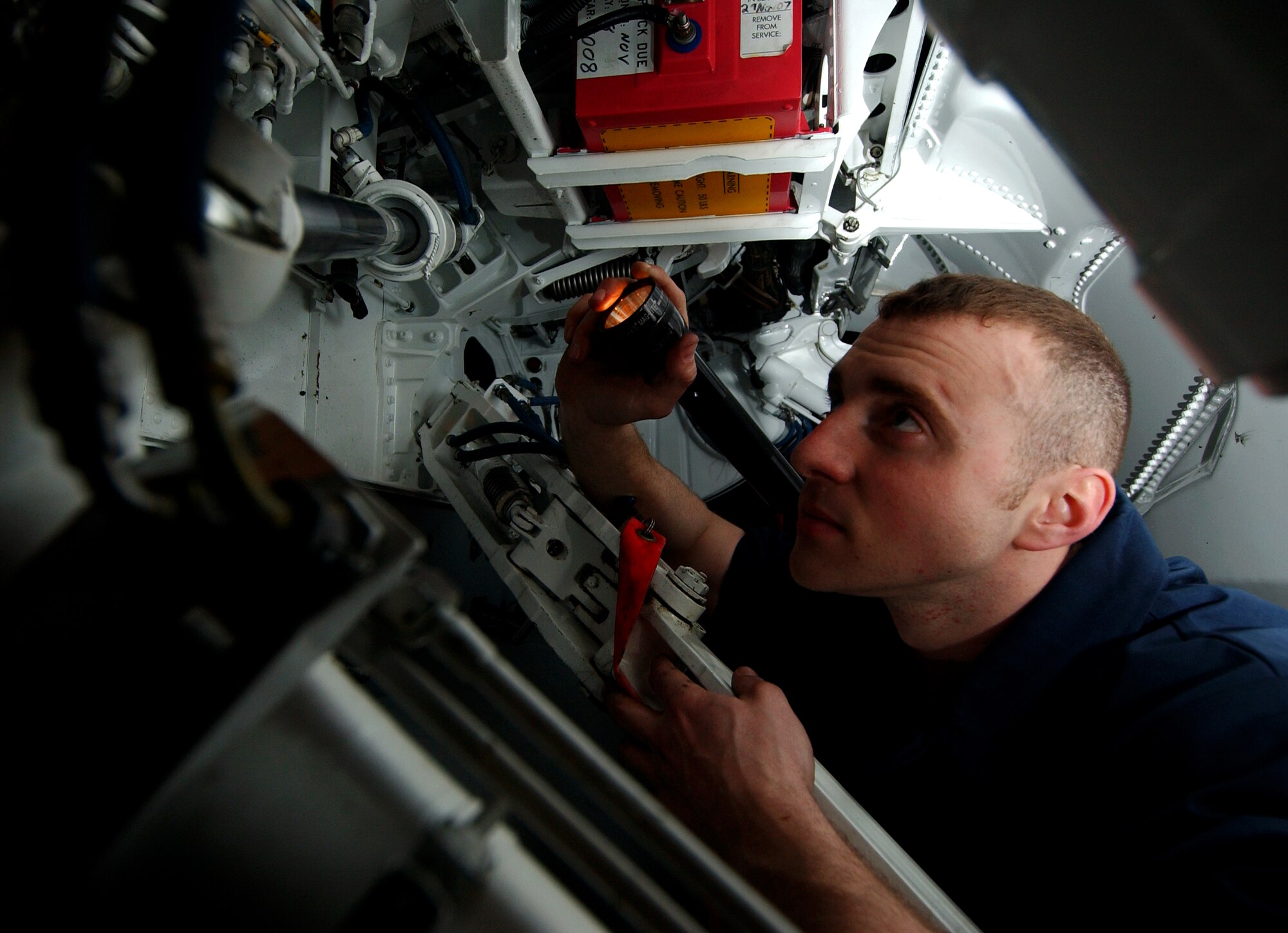 Airman 1st Class Jonathan Crump, 8th Maintenance Squadron, Kunsan AB, South Korea, inspects the main landing gear of an F-16 CG Falcon for damage during the 2008 Pacific Air Forces Operational Readiness Inspection at Kadena Air Base, Japan, March 12, 2008.  The 8th   Fighter Squadron jets are assisting the 18th Wing during the ORI by playing the role of “aggressors.”    PACAF is conducting the inspection from March 9 to 15 to validate the mission readiness of the 18th Wing. (U.S. Air Force photo/Tech. Sgt. Rey Ramon)  
