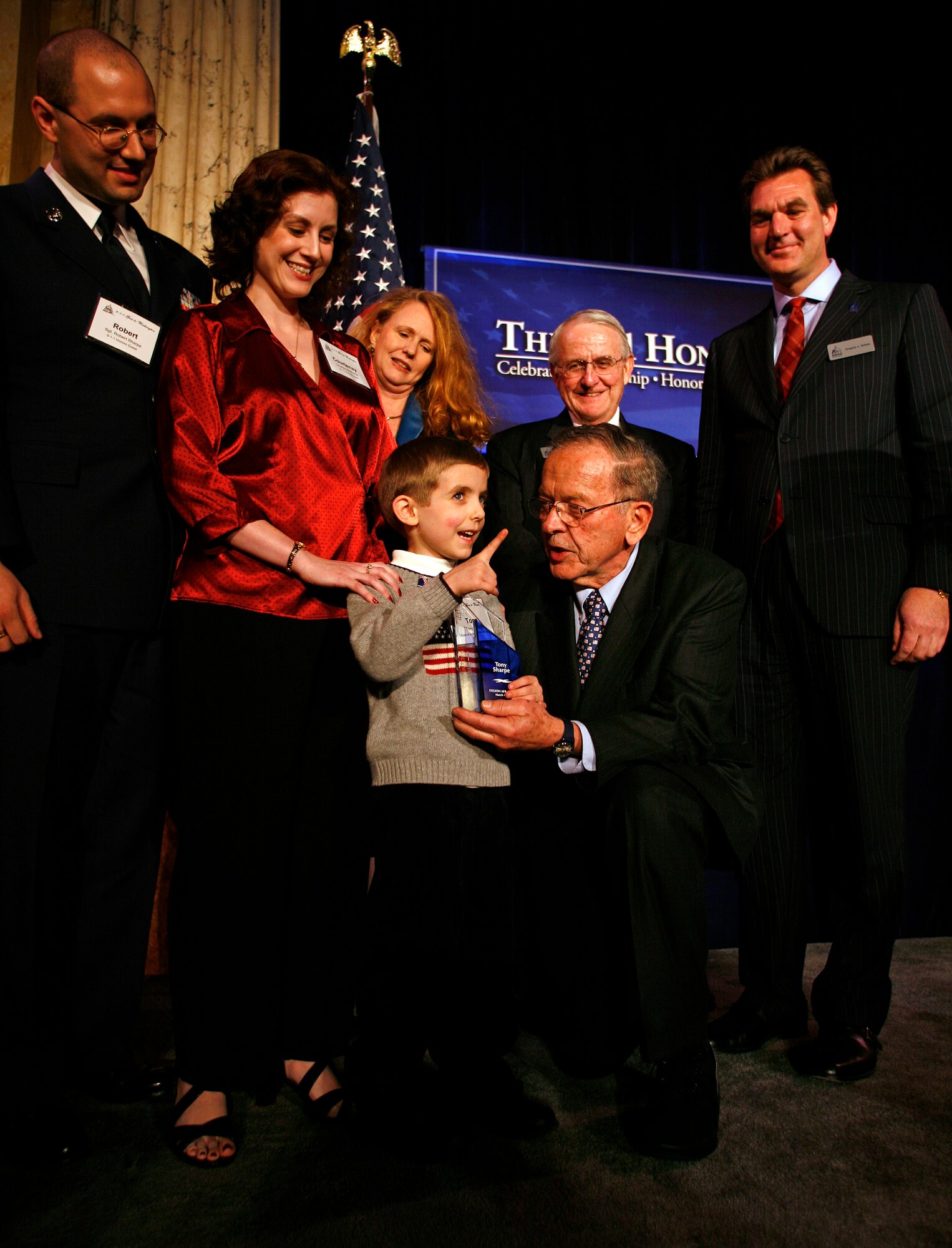 WASHINGTON D.C.--Tony Sharpe, the 5-year-old son of Courtenay and Tech. Sgt. Robert Sharpe, also pictured, is presented the 2007 Citizen in Action award from Sen. Ted Stevens (Alaska) at the E9-1-1 Gala at Union Station in Washinton, D.C. March 4, 2008. The boy saved his mother?s life last year when she had a gall bladder attack, without hesitation he summoned paramedics to his family?s apartment in North Pole by calling 911. Tony is one of eight people to be honored by the institute and the first Alaskan. He is also being honored by the American Red Cross of Alaska in Anchorage next month. (Photo by Martin Simon)