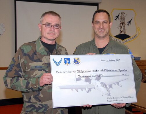 Col. Paul W. Comtois, 111th Fighter Wing commander, presents Master Sgt. David R. Austin, 111th Maintenance Squadron, a $10,000 check from the NGB Suggestion Program Feb. 10 at Willow Grove Air Reserve Station, Pa.  Austin developed an A-10 fuel systems tester that saved the Air Force almost $600,000.