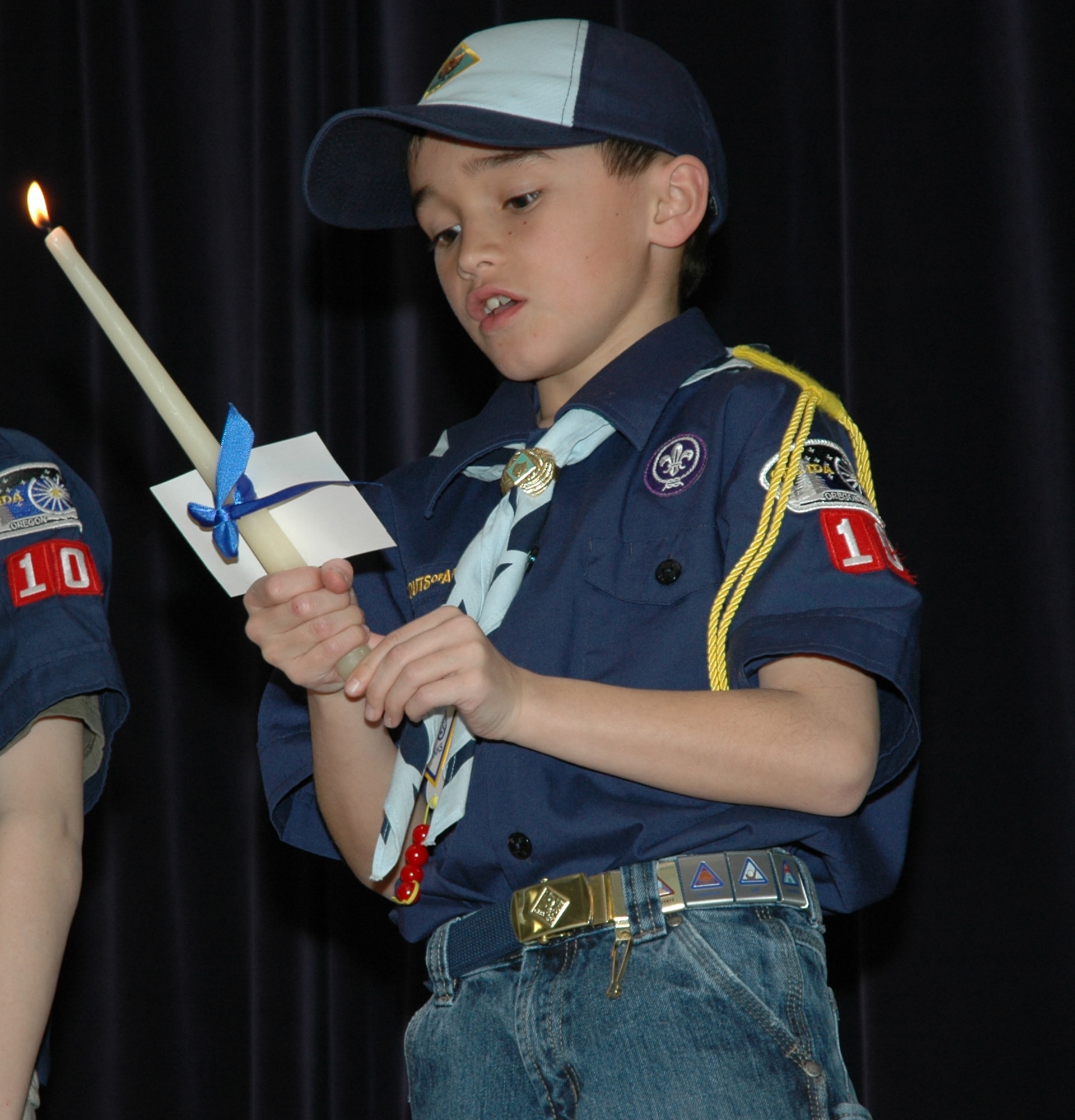 MOUNTAIN HOME AIR FORCE BASE, Idaho -- Cub Scout Dominick Finley recities one point of the Boy Scout Law during a candle lighting ceremony, Saturday at the Mountain Home Air Force Base Cub Scouts, Pack 102, 2008 Blue and Gold banquet Saturday. Each candle represents one of the 12 points of the Boy Scout Law. More then 80 scouts, den leaders, family and friends gathered to celebrate the Boy Scouts of America's birthday and congratulate those scouts who moved up in the ranks. (U.S. Air Force photo/ Senior Airman Megan P. Lyon)