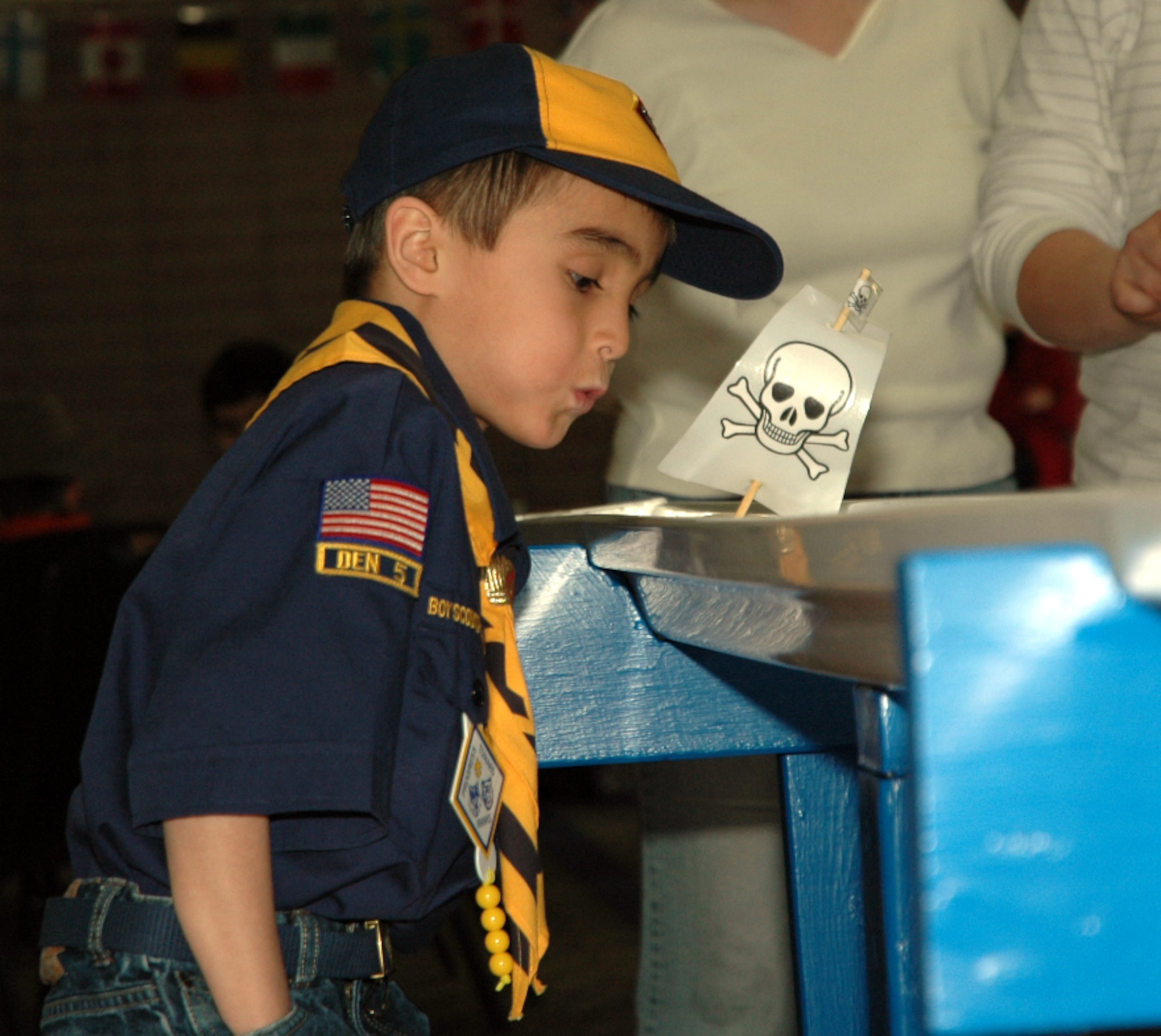 MOUNTAIN HOME AIR FORCE BASE, Idaho -- Cub Scout Austin Finley blows his sailboat toward the finish line during the rain gutter regatta race March 8 at the Mountain Home Air Force Base Cub Scouts, Pack 102, 2008 Blue and Gold banquet. More then 80 scouts, den leaders, family and friends gathered to celebrate the Boy Scouts of America's birthday and congratulate scouts who moved up in the ranks. (U.S. Air Force photo/ Senior Airman Megan P. Lyon)