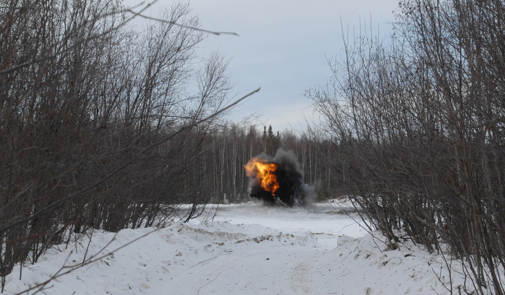 Along with a loud boom, five pounds of C4 plastic explosives detonate a practice unexploded ordnance (UXO) March 4, 2008 at Eielson Air Force Base.  The detonation was a training exercise to demonstrate the proper and safe procedures for detonating UXO's. (U.S Air Force photo by Staff Sgt. Eric T. Sheler)