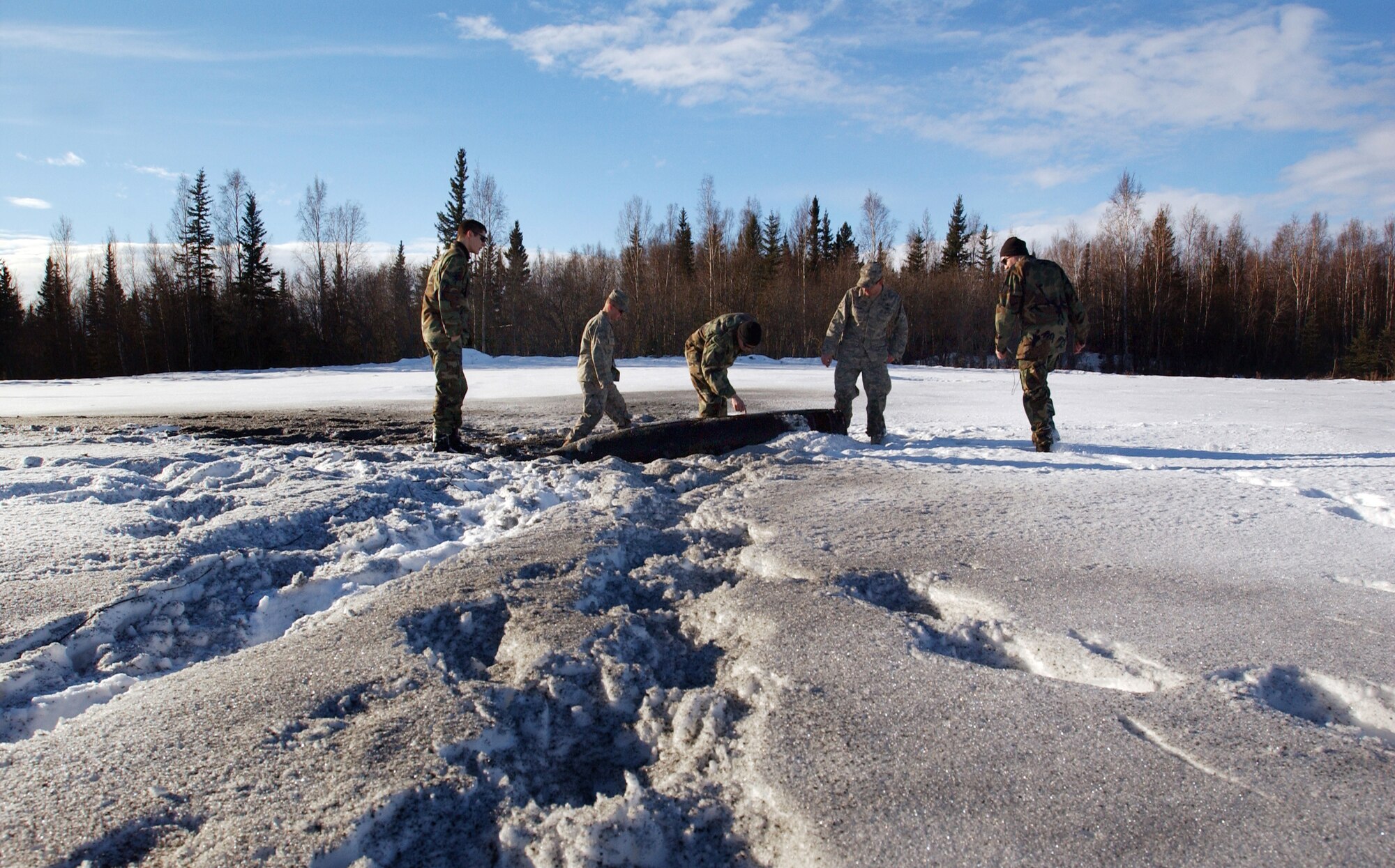 Members of the 354th Civil Engineer Squadron explosive ordnance disposal unit inspect a practice unexploded ordnance (UXO) for blast damage after it was detonated by five pounds of C4 plastic explosive Feb. 21, 2008 at Eielson Air Force Base, Alaska.  The detonation was a training exercise to demonstrate the proper and safe procedures for detonating UXO's. (U.S Air Force photo by Staff Sgt. Eric T. Sheler)
