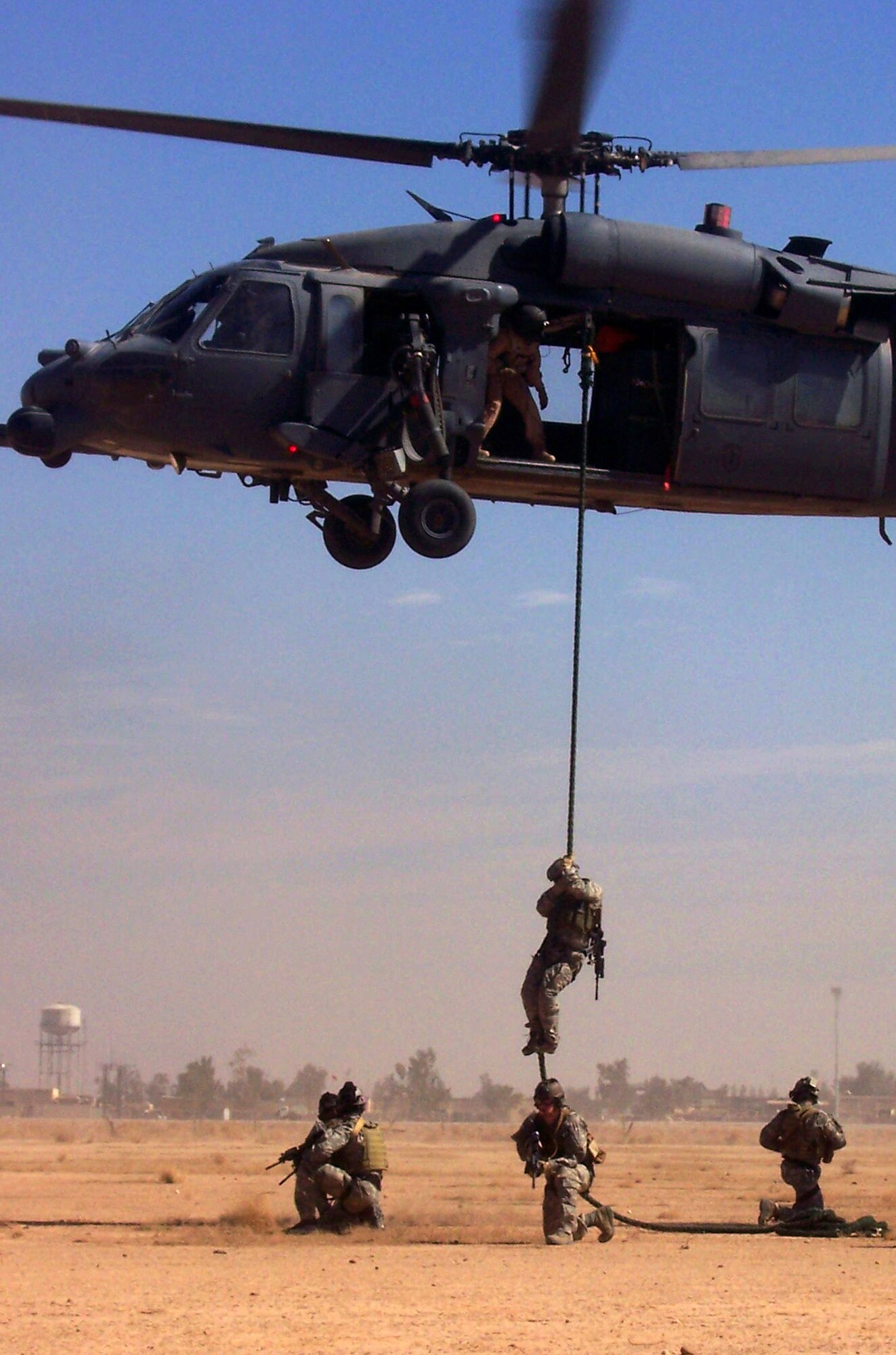 Servicemembers from the 64th Expeditionary Rescue Squadron fast rope from an HH-60G Pave Hawk helicopter and secure a 360-degree area March 6 at Balad Air Base, Iraq. Members of the squadron rescued two U.S. teachers who got lost while hiking in Iraq March 2. The rescue personnel are deployed from Nellis Air Force Base, Nev., and Moody Air Force Base, Ga. (U.S. Air Force photo/ Airman 1st Class April Mullens) 