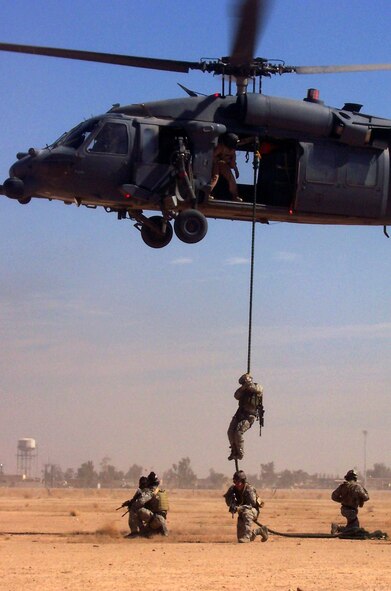 Servicemembers from the 64th Expeditionary Rescue Squadron fast rope from an HH-60G Pave Hawk helicopter and secure a 360-degree area March 6 at Balad Air Base, Iraq. Members of the squadron rescued two U.S. teachers who got lost while hiking in Iraq March 2. The rescue personnel are deployed from Nellis Air Force Base, Nev., and Moody Air Force Base, Ga. (U.S. Air Force photo/ Airman 1st Class April Mullens) 
