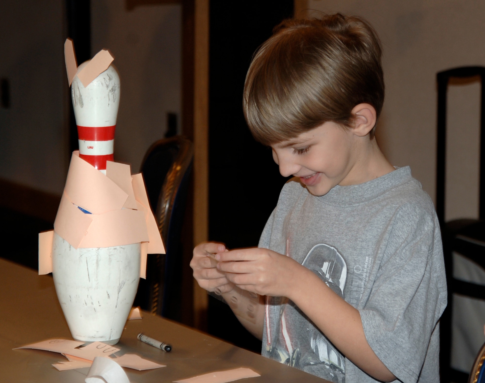 MCCONNELL AIR FORCE BASE, Kan. -- Ryan Casa, 6, creates a bunny out of construction paper and a bowling pin during a Bunny Bowl night March 10, at the Robert J. Dole Center’s Java Ops. The winning decoration will be announced on March 21, during Tornado Alley’s Pizza, Pop and Pins night. (photo by Airman Justin Shelton)

