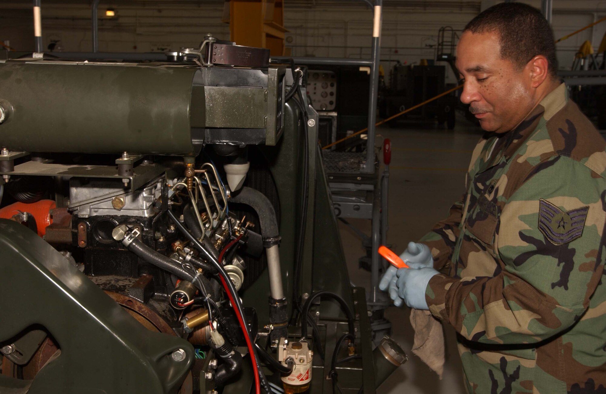 ANDREWS AIR FORCE BASE, Md. -- Tech. Sgt. Dwayne Robinson, 459th Maintenance Squadron aerospace ground equipment mechanic, performs an oil change on a nitrogen cart. (U.S. Air Force photo/Tech. Sgt. Eric Sharman)