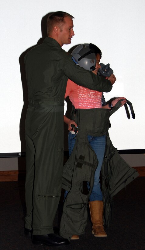 Second Lt. Jeremy Curbey, an officer at the 80th Operations Support Squadron, helps a junior high student put on flight gear March 6 at the 2008 Career Safari at the Multi-Purpose Events Center in Wichita Falls, Texas. Lieutenant Curbey, Capt. Lucas Gruenther, 80th OSS, and 1st Lt. David Mitchell, 80th OSS, spoke to students about the importance of getting an education to achieve future goals. (U.S. Air Force photo/Staff Sgt. Vernon Cunningham)