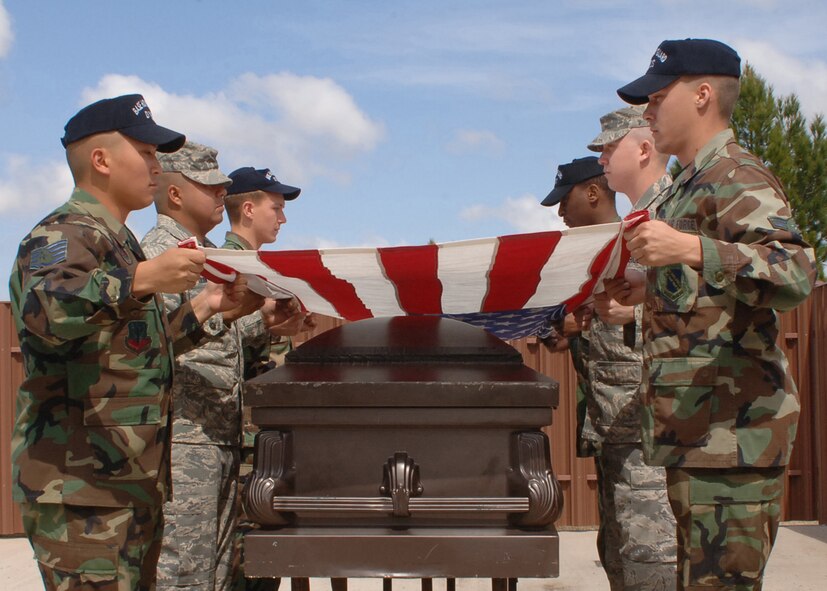 DYESS AIR FORCE BASE, Texas-- Members of the Dyess Honor Guard conduct a six-man flag fold, which are performed at funerals to honor fallen servicemembers or veterans, on March 10. All the Airmen involved in Honor Guard have volunteered to be a member.(U.S Air Force photo by Airman 1st Class Felicia Juenke)