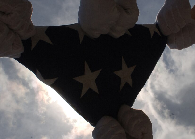 DYESS AIR FORCE BASE, Texas-- Dyess Honor Guard members fold the American flag on March 10. The Dyess  Honor Guard performs the flag folding sequence at different military events.(U.S Air Force photo by Airman 1st Class Felicia Juenke)