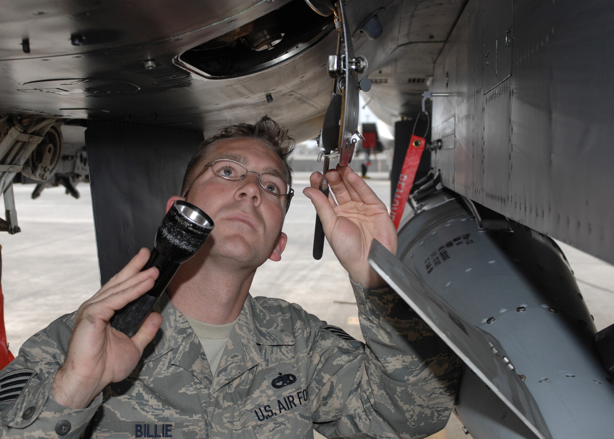 Staff Sgt. Jonathan Billie inspects the airframe mounted accessories drive on an F-15E Strike Eagle here March 11.   Sergeant Billie, an F-15 crew chief, is assigned to 335th Expeditionary Aircraft Maintenance Unit here, and is deployed from the 335th Aircraft Maintenance Unit, Seymour Johnson Air Force Base, N.C. (U.S. Air Force photo by Master Sgt. Demetrius Lester)