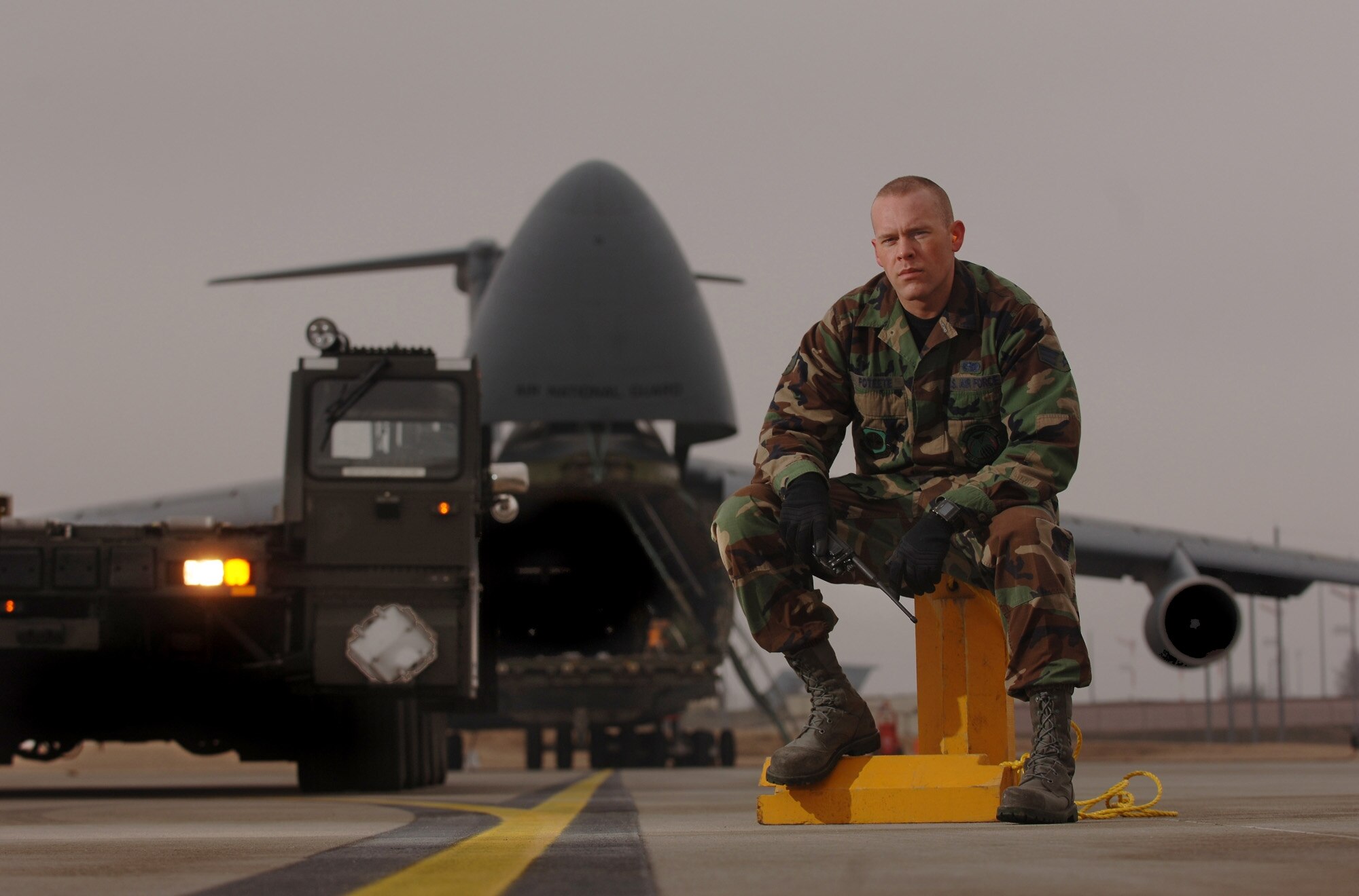 SPANGDAHLEM AIR BASE, Germany -- Air Transportation specialist, Senior Airman Jason Poteete and a 60K loader waits on the hot cargo pad here ready to service a C-5 Galaxy returning from down range with explosive cargo. Airman Poteete is assigned to the 726th Air Mobility Squadron. (U.S. Air Force photo/Master Sgt. Scott Wagers)