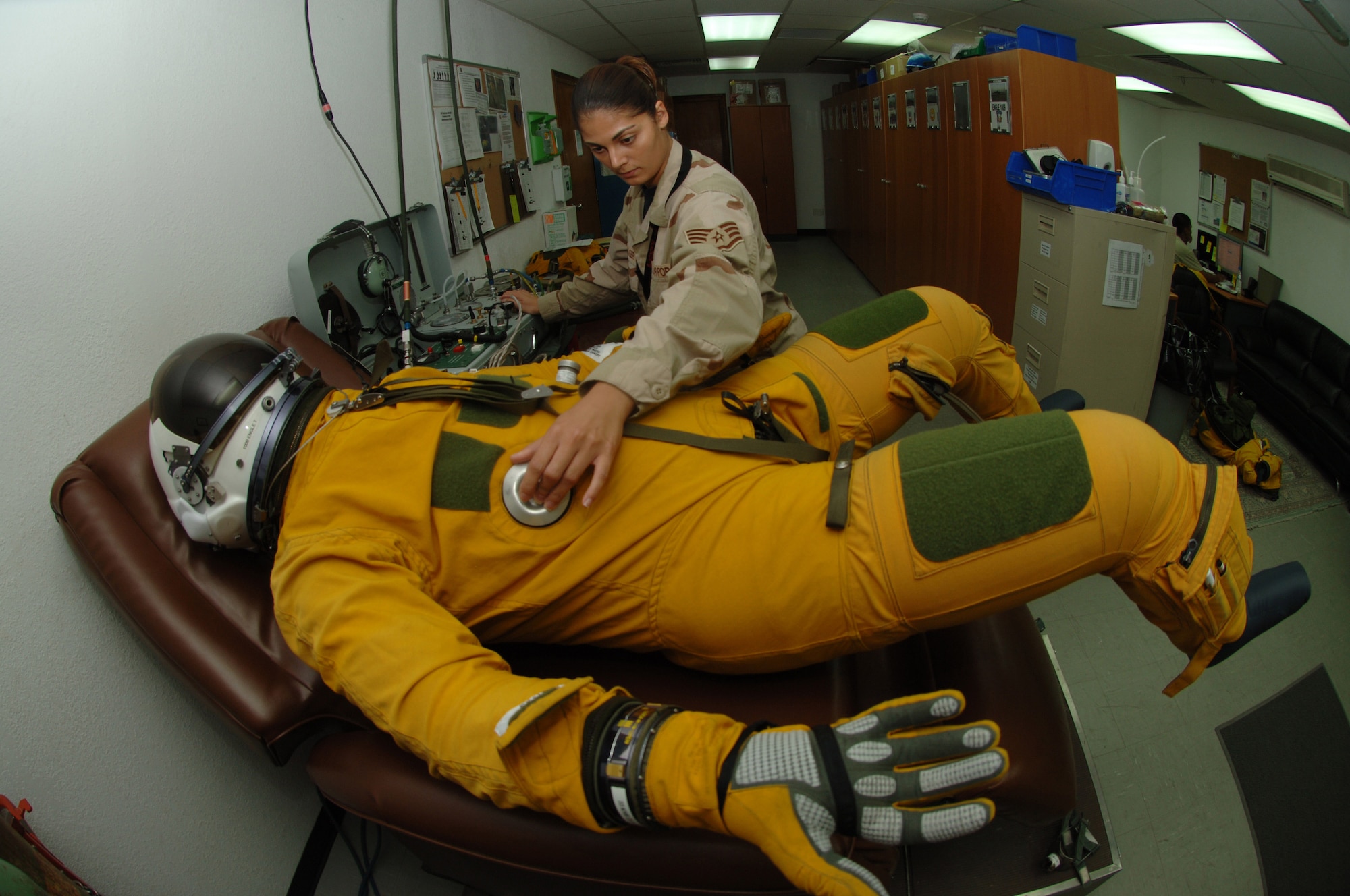 Staff Sgt. Nikolina Kreager, a life support specialist with the 99th Expeditionary Reconnaissance Squadron at an air base in Southwest Asia, ensures a U-2 Dragon Lady pilot is set for the day's mission by checking the flight suit to make sure it can pressurize properly at high altitudes.  The 380th Air Expeditionary Wing hosts the only U-2 squadron in the area of responsibility, providing high-altitude intelligence, surveillance and reconnaissance for support in winning the war on terror.(U.S. Air Force photo/Senior Airman Levi Riendeau)