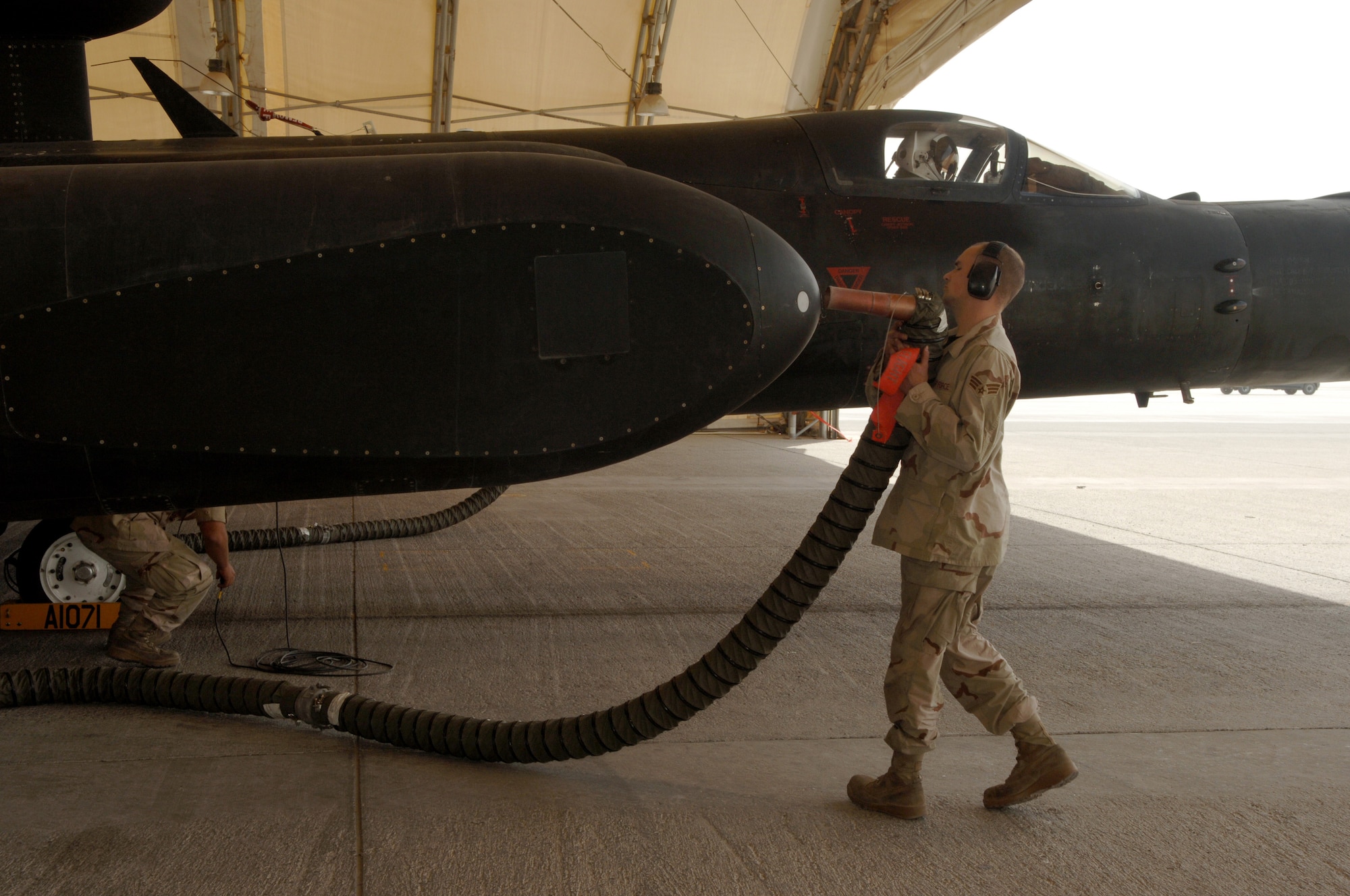 Senior Airman Jonathan Cantrell, a crew chief with the 99th Aircraft Maintenance Unit at an air base in Southwest Asia, removes the cooling tube from a U-2 Dragon Lady sensor pod Mar. 5 as the pilot prepares to take off for a mission.  The 380th Air Expeditionary Wing hosts the only U-2 squadron in the area of responsibility, providing high-altitude intelligence, surveillance and reconnaissance for support in winning the war on terror.(U.S. Air Force photo/Senior Airman Levi Riendeau)