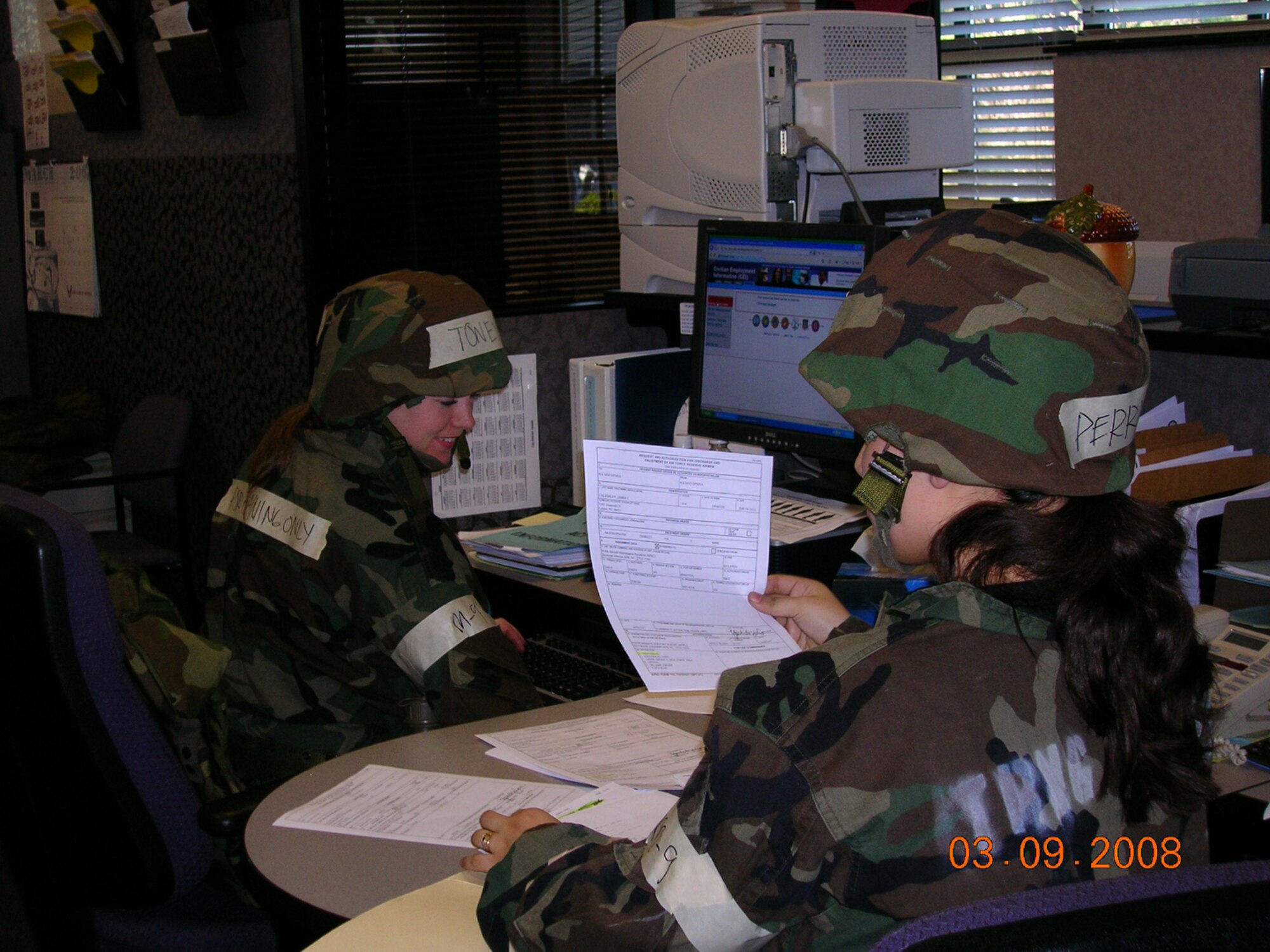 SEYMOUR JOHNSON AIR FORCE BASE, N.C. -- Senior Airman Maria Perry (right) continues to show her ability to operate in a simulated hostile environment along with Staff Sgt. Shelly Toney. Both are reservists with the 916th Mission Personnel Flight and were active participants in the wing's mock exercise during the March unit training assembly.