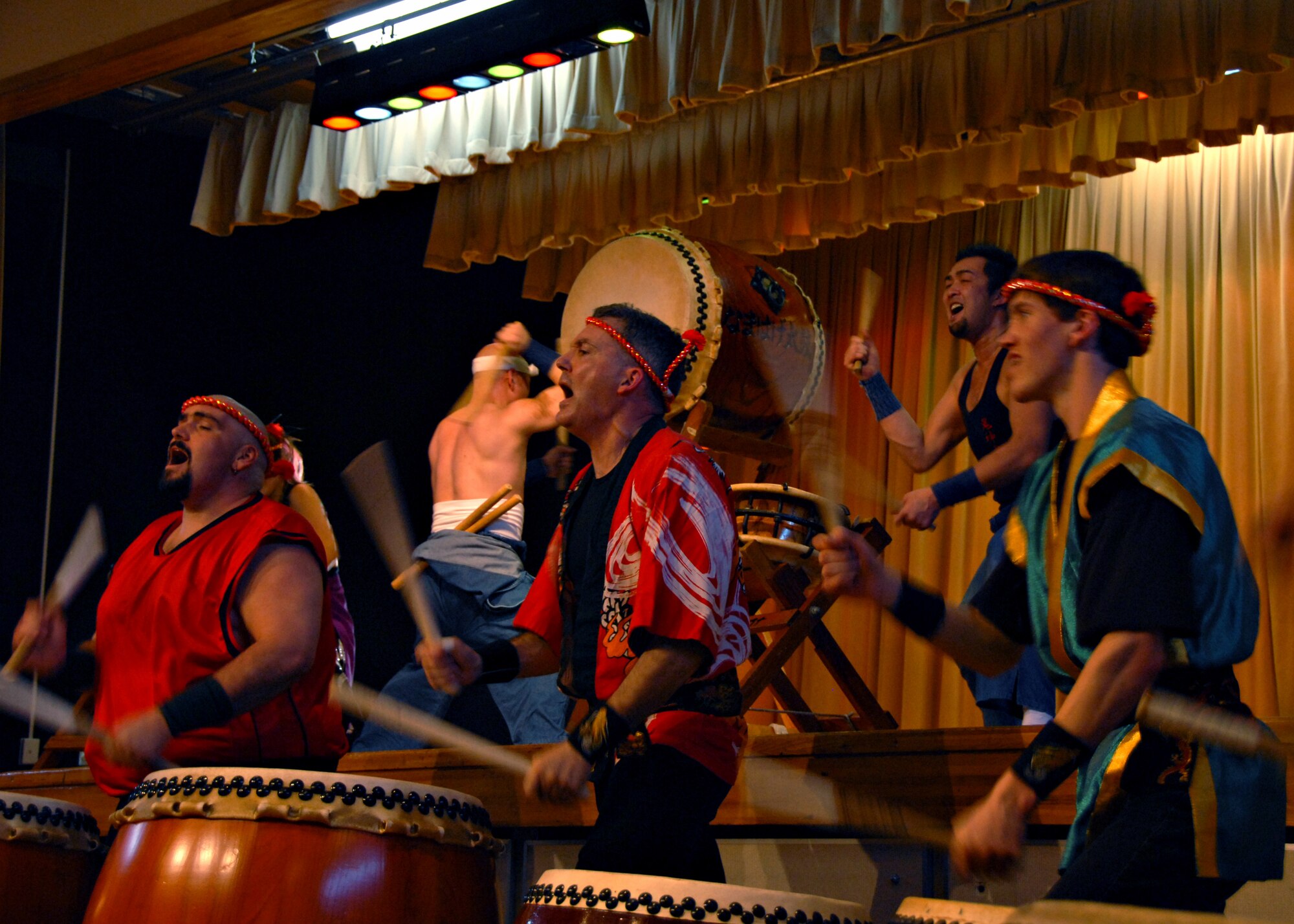 MISAWA AIR BASE, Japan -- Left to right, David Wray, Matt Duston and Randy Haltli, members of Misawa's Dragon-Eagle Taiko Team, perform with professional Taiko team members in the background. The professional team traveled from Akita Prefecture in northern Japan and said they enjoyed performing for and with the Americans because of their spirit and enthusiasm. (U.S. Air Force photo by Staff Sgt. Rachel Martinez)