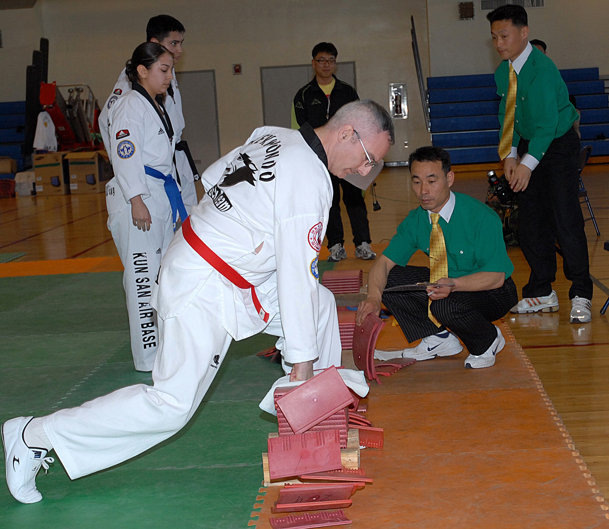 KUNSAN AIR BASE, Republic of Korea -- Lieutenant Colonel Kenneth Pascoe, from the 8th Fighter Wing, breaks boards during the base Taekwondo tournament here Jan. 30. The tournament is held annually as an opportunity for Airmen from the 8th FW and the Republic of Korea Air Force's 38th Fighter Group to strengthen their relationship, learn more about each others culture and test their martial arts skills.  (U.S. Air Force photo/Mr. Yi, Hak Song)