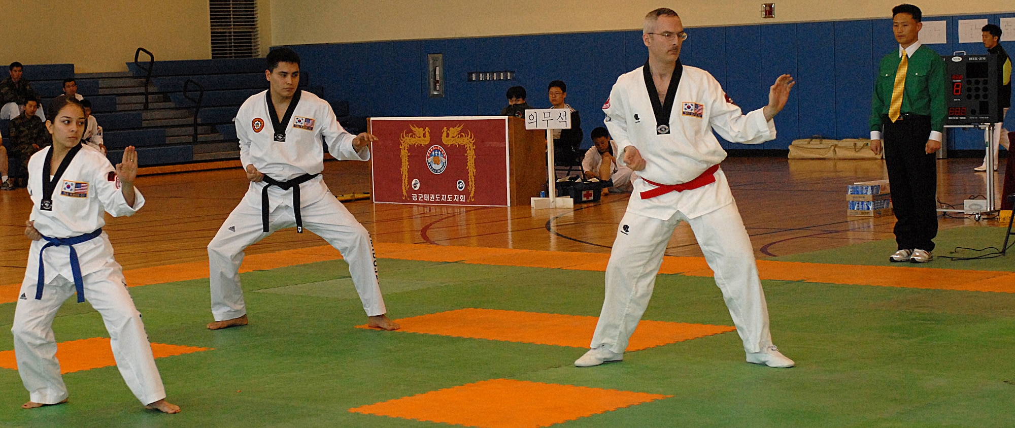 KUNSAN AIR BASE, Republic of Korea -- Senior Airmen Brenna Reynolds and Aaron Taylor, 8th Maintenance Squadron, and Lt. Col. Kenneth Pascoe, from the 8th Fighter Wing, perform Poomsae during the base Taekwondo tournament here Jan. 30. The tournament is held annually as an opportunity for Airmen from the 8th Fighter Wing and the Republic of Korea Air Force's 38th Fighter Group to strengthen their relationship, learn more about each others culture and test their martial arts skills.  (U.S. Air Force photo/Senior Airman Giang Nguyen)

