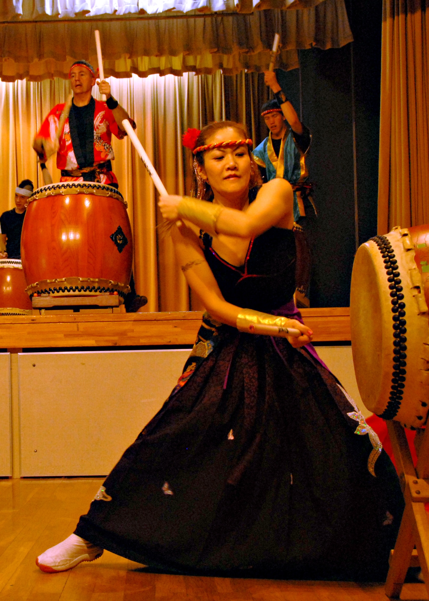 MISAWA AIR BASE, Japan -- Kazuko Igarashi, Dragon-Eagle Taiko Team coach, demonstrates Taiko side drumming technique during a performance at the Mokuteki Community Center March 8. Igarashi-san is the Taiko instructor on base and was made an honorary member of the professional Kijinsyu Taiko Team for her self-less dedication to teaching Americans. (U.S. Air Force photo by Staff Sgt. Rachel Martinez)