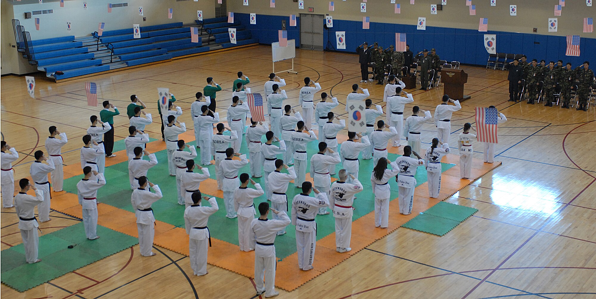 KUNSAN AIR BASE, Republic of Korea -- Members of U.S. and Republic of Korea Air Forces render salute at the base Taekwondo tournament opening ceremony here Jan. 30. The tournament is held annually as an opportunity for Airmen from the 8th Fighter Wing and the Republic of Korea Air Force's 38th Fighter Group to strengthen their relationship, learn more about each others culture and test their martial arts skills.  (U.S. Air Force photo/Senior Airman Giang Nguyen)