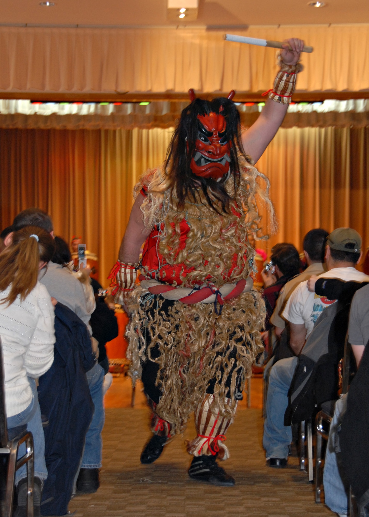 MISAWA AIR BASE, Japan -- David Wray, Misawa's Dragon-Eagle Taiko team captain, marches down the aisle dressed in a traditional Namahage costume during a performance at the Mokuteki Community Center March 8. The Dragon-Eagle Taiko Team performed with a professional Takio group, the Kijinsyu Taiko Team. (U.S. Air Force photo by Staff Sgt. Rachel Martinez) 