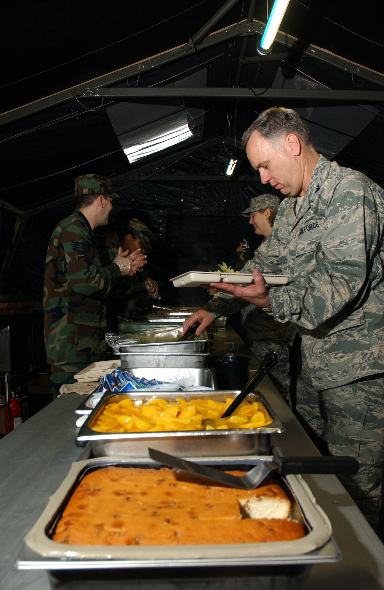 Col. Clifton Perry, 18th Wing chaplain, chooses from a variety of food offered by the 18th Services Squadron single pallet expeditionary kitchen during the 2008 Pacific Air Forces Operational Readiness Inspection at Kadena Air Base, Japan, March 11, 2008. The deployable kitchen can be set up from pallet to serving in under four hours. PACAF is conducting the inspection from March 9 to 15 to validate the mission readiness of the 18th Wing.  (U.S. Air Force photo/Senior Airman Jeremy McGuffin)