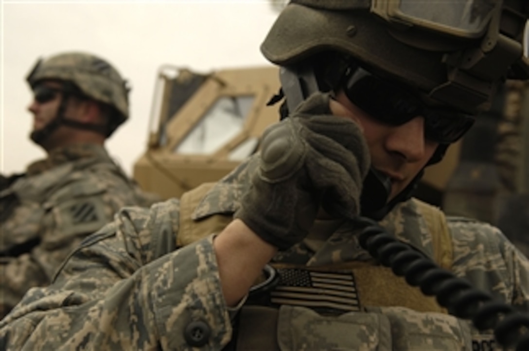 U.S. Air Force Senior Airman Joseph Aton, a joint terminal attack controller deployed with the 2nd Brigade Combat Team, 3rd Infantry Division, calls in an airstrike on an insurgent torture house and prison in Northern Zambraniyah, Iraq, on March 10, 2008.  