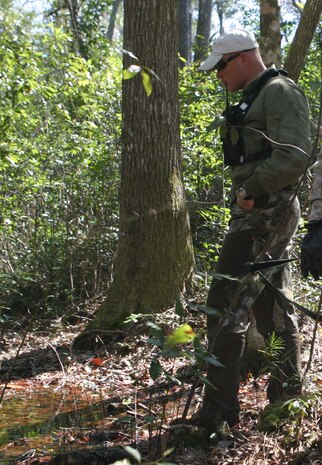 Bob Detzel, a technical training officer, Chemical Biological Incident Response Force, II Marine Expeditionary Force, explains the training that CBIRF basic operations course students receive to representatives of the Israeli government here March 12. The Israelis visited with Marines and sailors from CBIRF and toured the unit?s training area. Two years ago, a group of Israeli personnel participated in the CBIRF Basic Course.