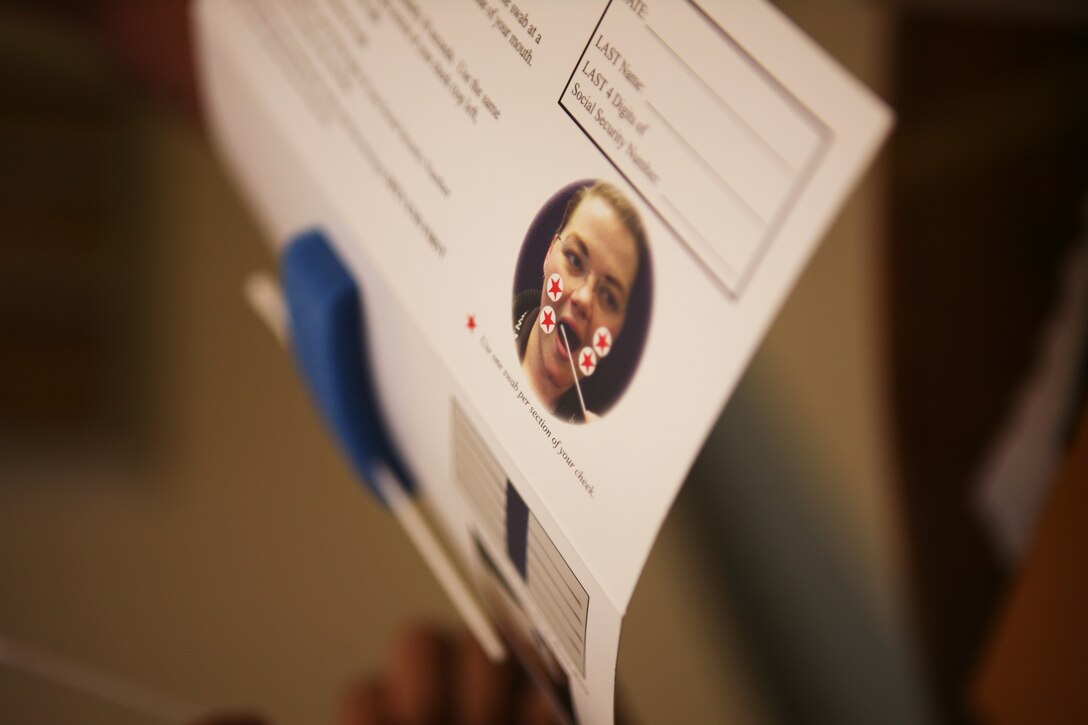 A packet shows the short and easy instructions on swabbing and where to place the swabs during a bone marrow drive in front of the Pollack Theater, here March 13.