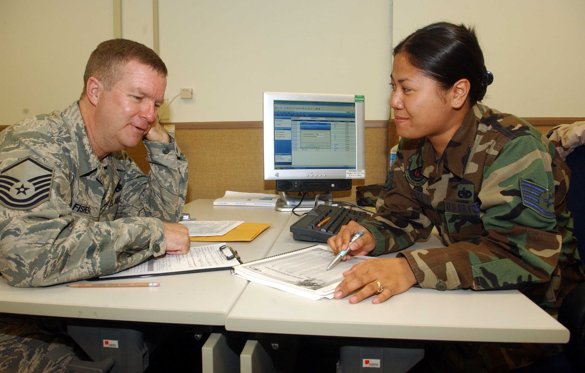 Staff Sgt. Carolyn Gettler, (right), tax center volunteer from the 51st Maintenance Operations Squadron, discusses itemized tax deductions with Master Sgt. David Fisher, 51st Maintenance Operations Squadron, March 11. Located in Bldg. 788, Room 26, the tax center offers a variety of free services including electronic filing and preparation of federal income taxes. It is open Tuesday through Thursday from 8:30 to 11:30 a.m., and 12:30 to 1:30 p.m. Individuals filing a 1040EZ return may walk in. Other services will be provided on an appointment basis. For more information, call 784-0888. (U.S. Air Force photo/Staff Sgt. Candy Knight)