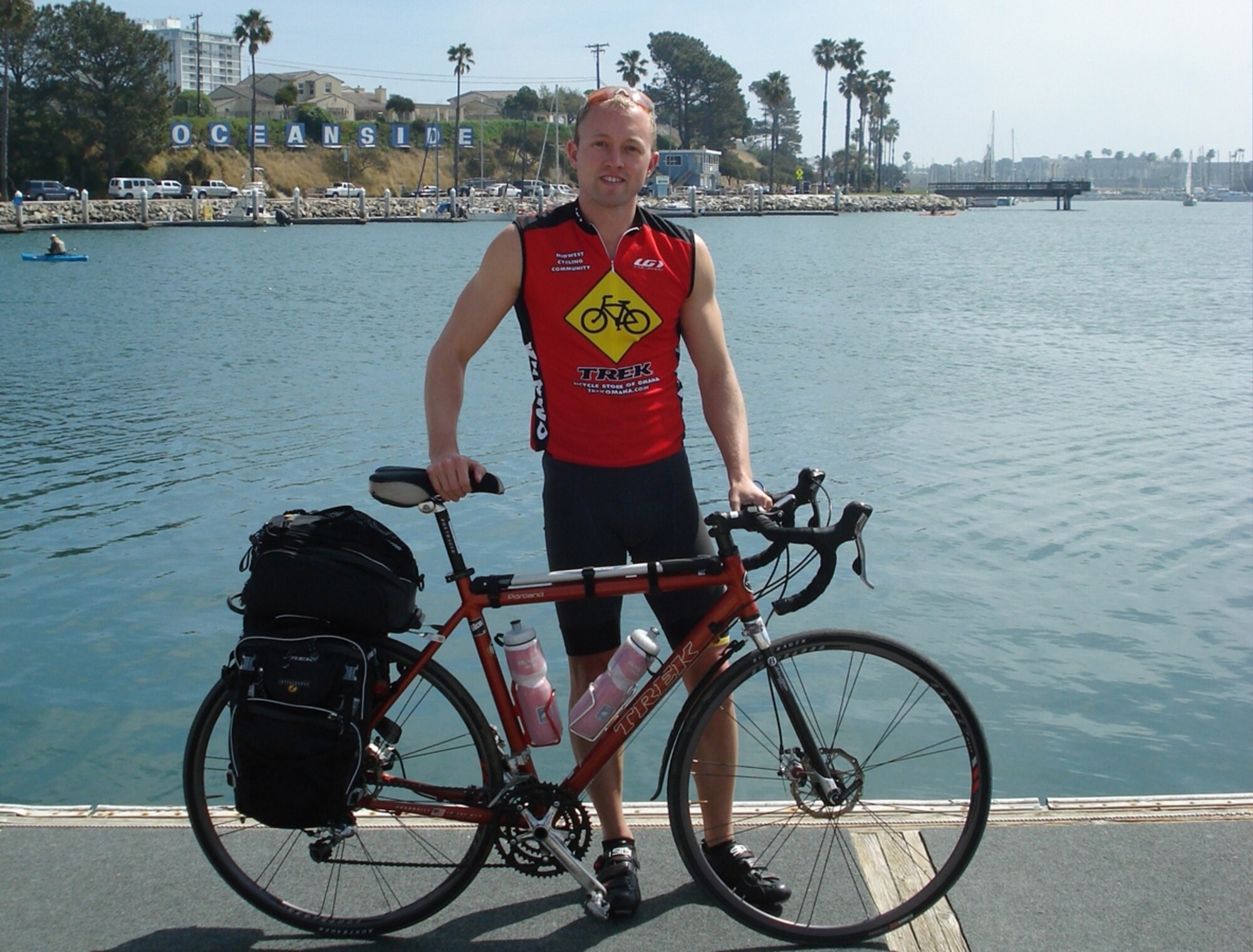 Navy Lt. Jeffrey Greene prepares to start his three-month journey in Oceanside, Calif., by dipping his bike tires in the Pacific Ocean. For more on the trip or to follow Lieutenant Greene’s progress, visit www.rideforred.com. (Courtesy Photo)