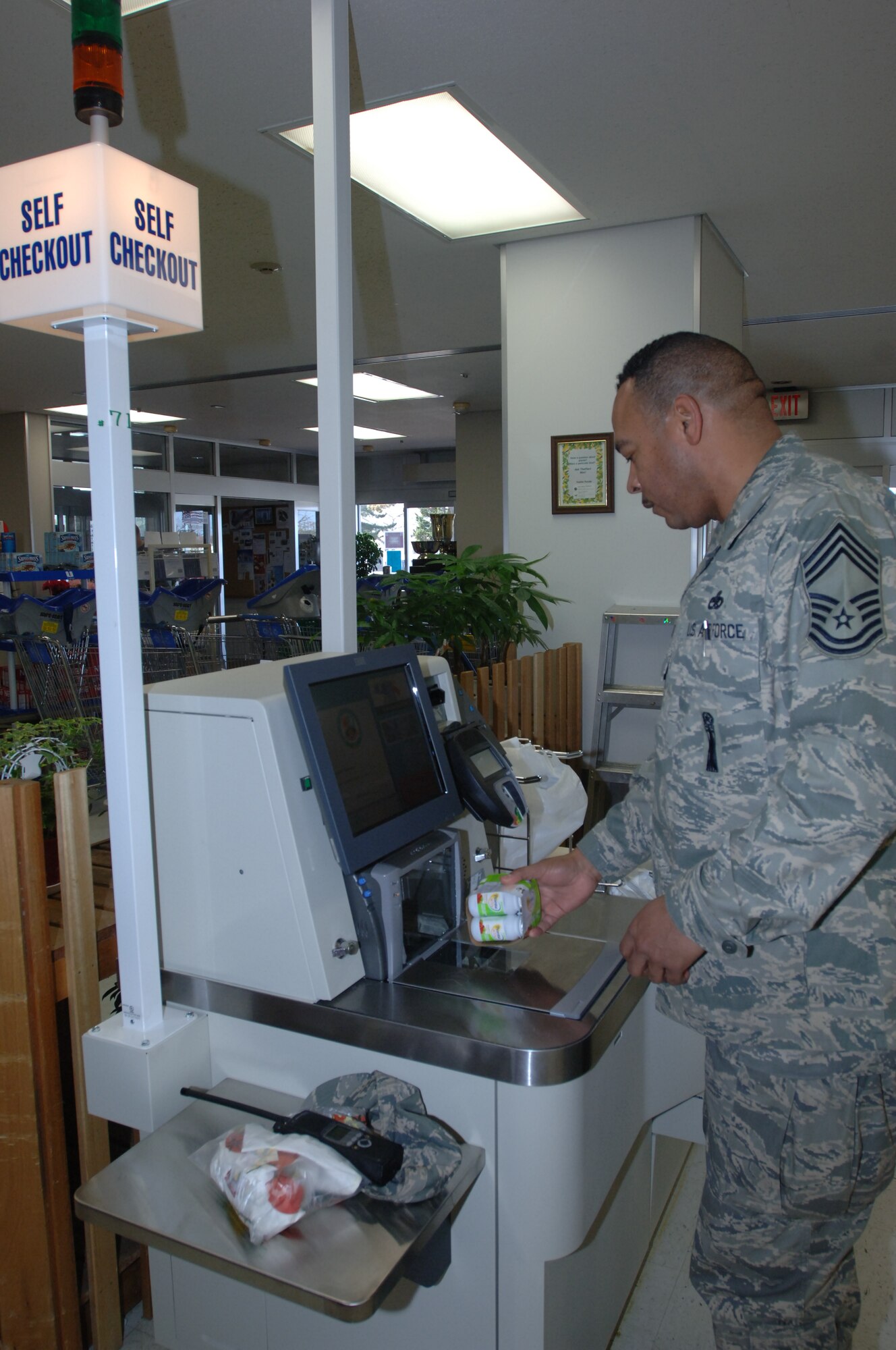 MISAWA AIR BASE, Japan -- Chief Master Sgt. Antonio Johnson, 35th Maintenance Squadron, uses the new self-help check out machines at the base commissary Mar. 12, 2008. In addition to the self-checkout registers, the commissary has installed new state-of-the-art registers that will reduce the time customers wait in line. (U.S. Air Force photo by Senior Airman Robert Barnett)