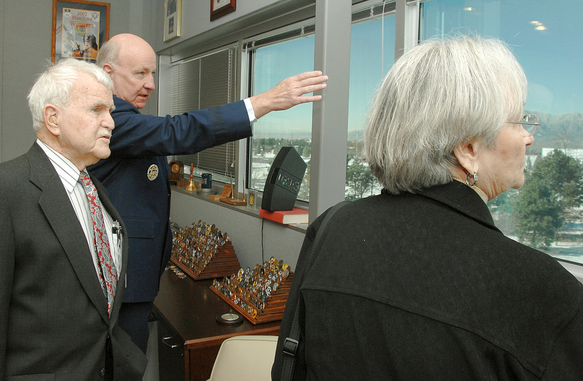 Retired Col. Francis "Joe" Hale takes in the sights from Air Force Space Command Headquarters at Peterson Air Force Base, Colo., with his wife Mary Alice and Maj. Gen. Thomas Deppe, AFSPC vice commander. The colonel, recently inducted into the Air Force Space and Missile Pioneers Hall of Fame, was honored by Space Command officials March 6 for his many contributions to the U.S. space and missile program. (U.S. Air Force photo/Tech. Sgt. Matt Lohr)