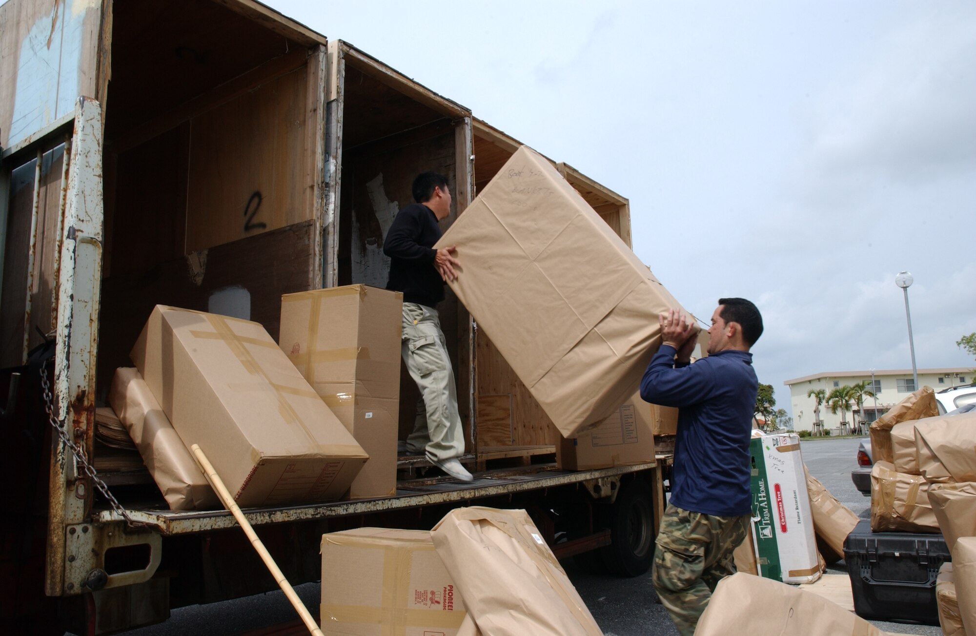 Movers load up household good  of Kadena personel leaving to their next assignment March 13.  Accompanied families arriving to Kadena Air Base will now be able to bring their full weight allowance for goods, due to a policy change that was implemented March 1. Pacific Air Forces initiated a study in 2006 that suggested allowing a 100 percent Joint Federal Travel Rate Regulation for weight entitlements to help cut down on costs. Prior to the change, members could only bring 25 percent of their allotted household good weight.
(U.S. Air Force photo/Senior Airman Jeremy McGuffin) 