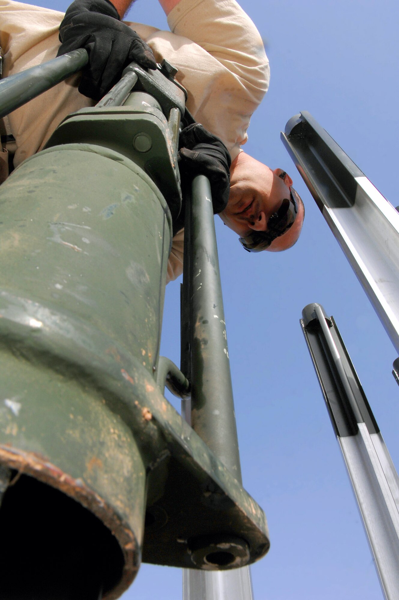 Tech. Sgt. Randy Thibeau holds a stake hammer as it pounds four-foot stake into the ground March 12 at Balad Air Base, Iraq. The stake prevents the arresting barrier system from shifting during an emergency landing. The barrier system gives the Air Force the ability to launch aircraft and recover them anywhere in the world. If a fighter aircraft experiences malfunctioning landing gear, the pilot can a drop a hook to catch a cable attached to the barrier system, which slows the aircraft and enables a smoother landing. Sergeant Thibeau is a 332nd Expeditionary Civil Engineer Squadron power production technician deployed from Ellsworth Air Force Base, S.D. (U.S. Air Force photo/Senior Airman Julianne Showalter) 