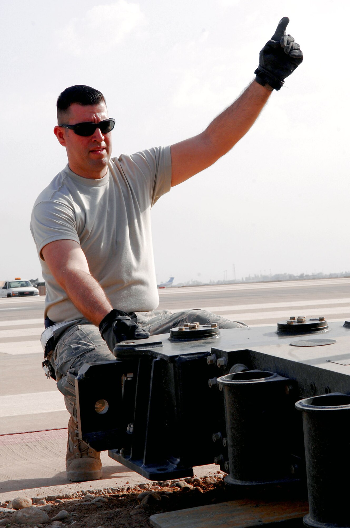 Tech. Sgt. Emmanuel Ramirez guides a forklift to place an arresting barrier system on the runway March 12 at Balad Air Base, Iraq. The system is composed of a cable stretched out across the runway attached to a braking system that brings fighter aircraft to a smooth halt during emergency landings. Sergeant Ramirez is a 332nd Expeditionary Civil Engineer Squadron power production technician deployed form Peterson Air Force Base, Colo. (U.S. Air Force photo/Senior Airman Julianne Showalter) 