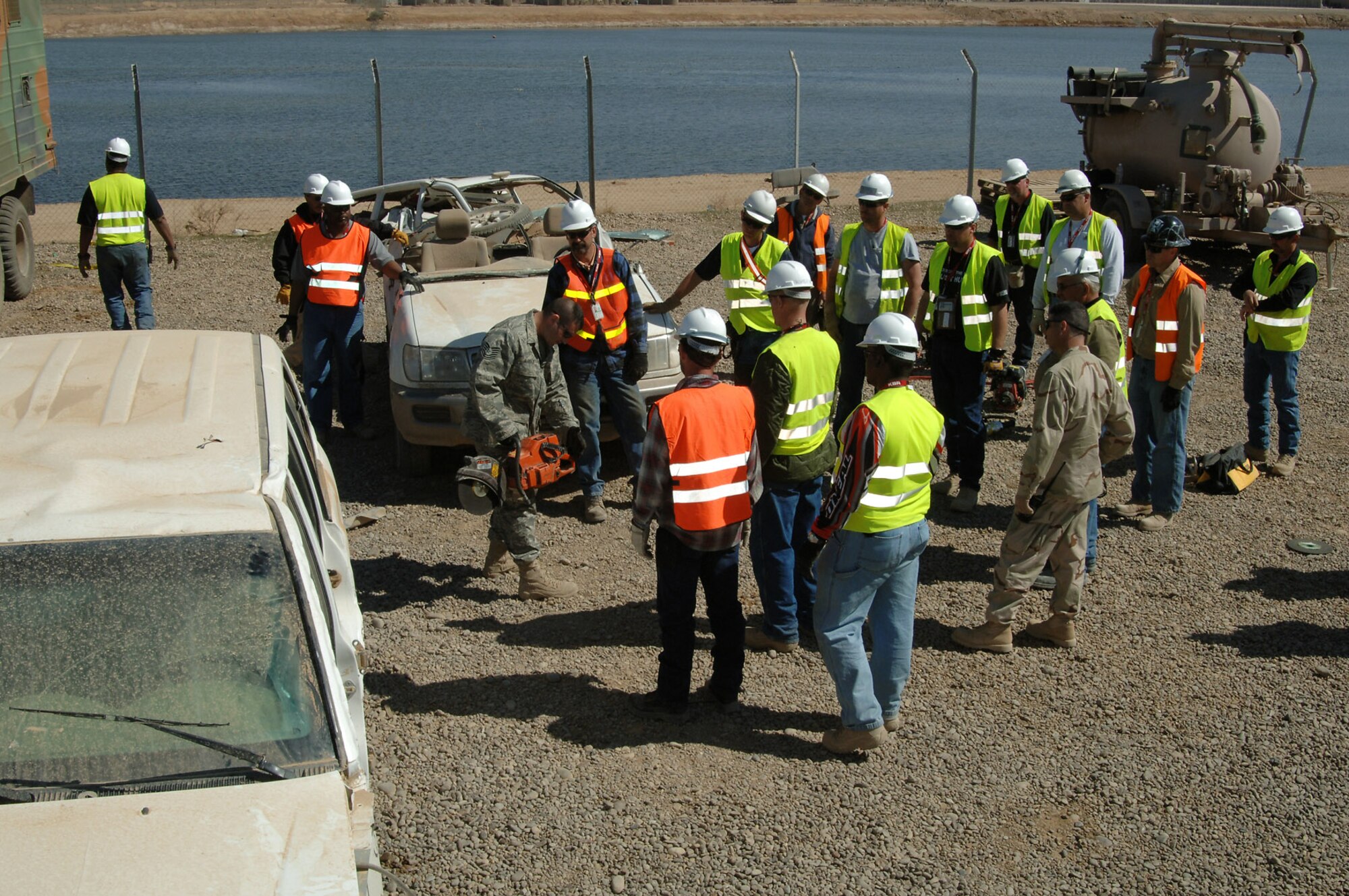Tech. Sgt. Christopher McArdle demonstrates for KBR Theater Transportation Mission Recovery senior mechanics the proper way to wield a circular saw during a refresher training session on using hydraulic tools March 5 at Balad Air Base, Iraq. The class, a first for the Balad AB fire department, marked an important step for the U.S. government contractors to train jointly with Airmen. The TTM Recovery personnel are responsible for retrieving stuck, broken down and destroyed military vehicles throughout Iraq. Sergeant McArdle is a 332nd Expeditionary Civil Engineer Squadron Fire Department firefighter. (U.S. Air Force photo/Master Sgt. Heather Cabral)