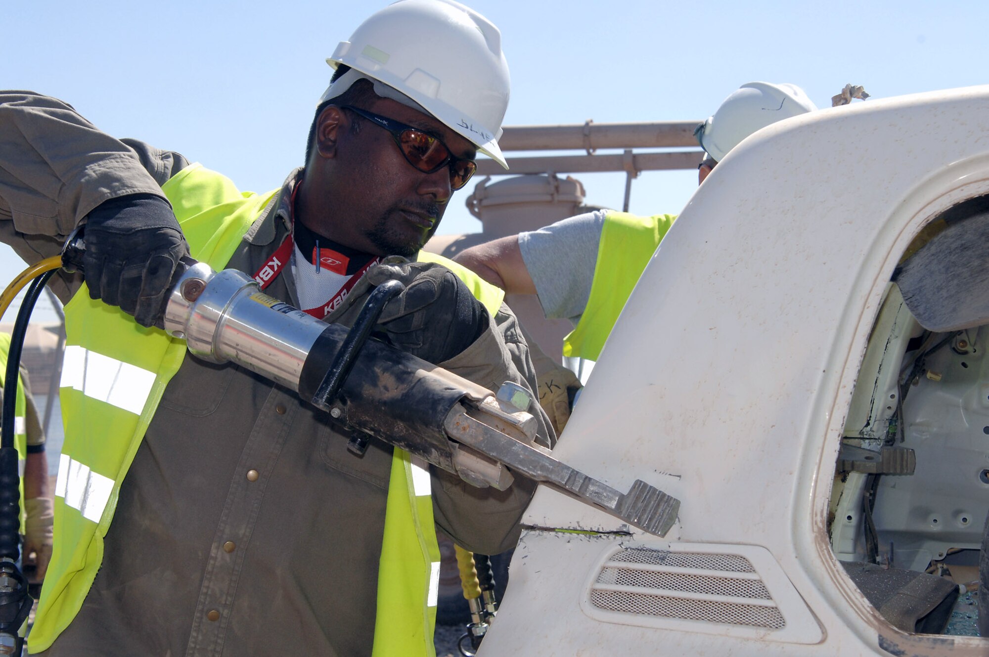 A KBR Theater Transportation Mission Recovery senior mechanic tests the strength of a combination spreader shear, or "mini Jaws of Life," tool by cutting into a test vehicle during a refresher training session on using the tools March 5 at Balad Air Base, Iraq. The class was led by 332nd Expeditionary Civil Engineer Squadron Fire Department Airmen. The combination spreader shear can exert 20,900 pounds per square inch of force at their tips and can both cut and force apart vehicle parts. The U.S. government contracted senior mechanics are responsible for retrieving stuck, broken down and destroyed military vehicles throughout Iraq. The tools help them to cut away obstacles from stuck vehicles as well as get inside of vehicles in the event someone is trapped inside. (U.S. Air Force photo/Master Sgt. Heather Cabral) 
