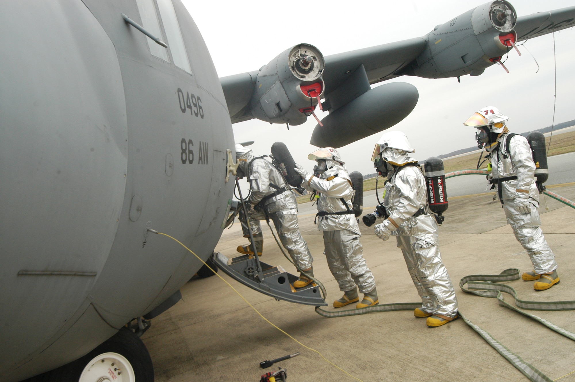 Firefighters enter the buring C-130 to douse the simulated fire during the training exercise Tuesday. U. S. Air Force photo by Sue Sapp 