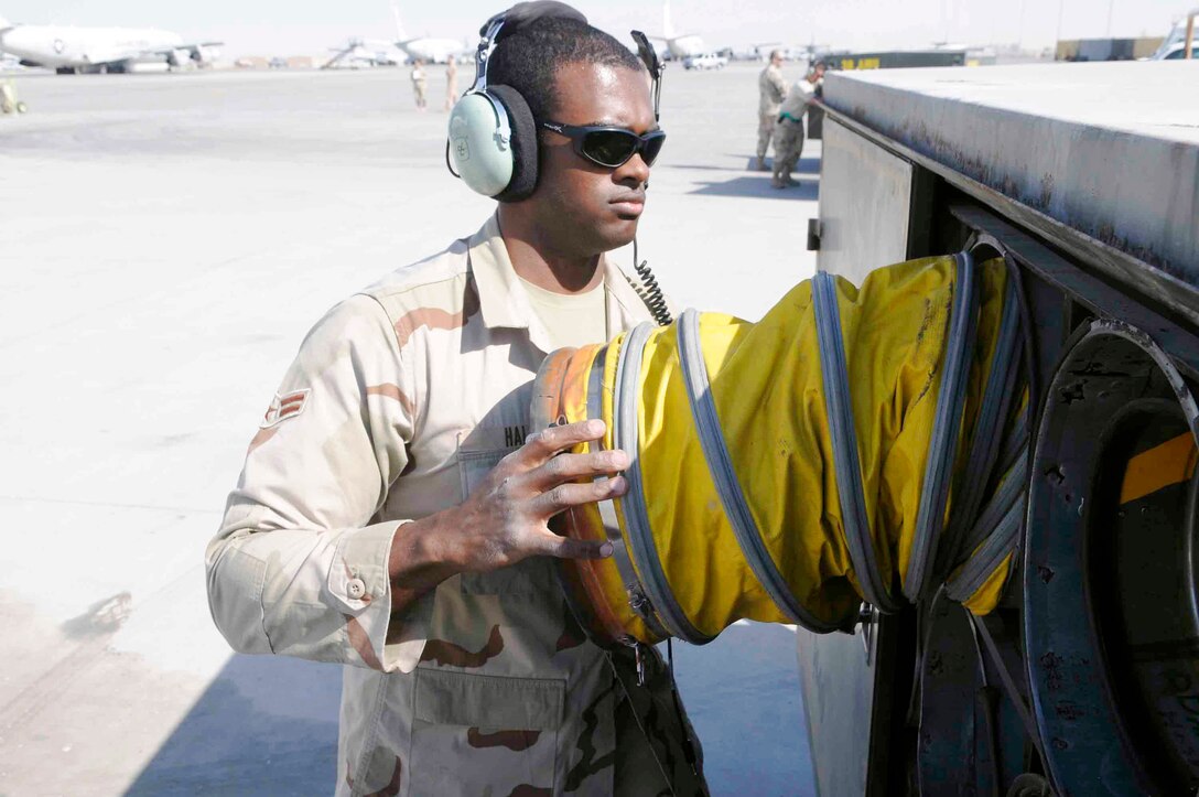 Airman 1st Class Michael Hall stores hoses removed from an RC-135 Rivet Joint March 12 at a Southwest Asia air base. Aircraft hoses are used to keep the inside of the aircraft cool. Airman Hall, assigned to the 379th Expeditionary Reconnaissance Squadron, is deployed from Offutt Air Force Base, Neb. (U.S. Air Force photo/Tech. Sgt. Johnny L. Saldivar) 