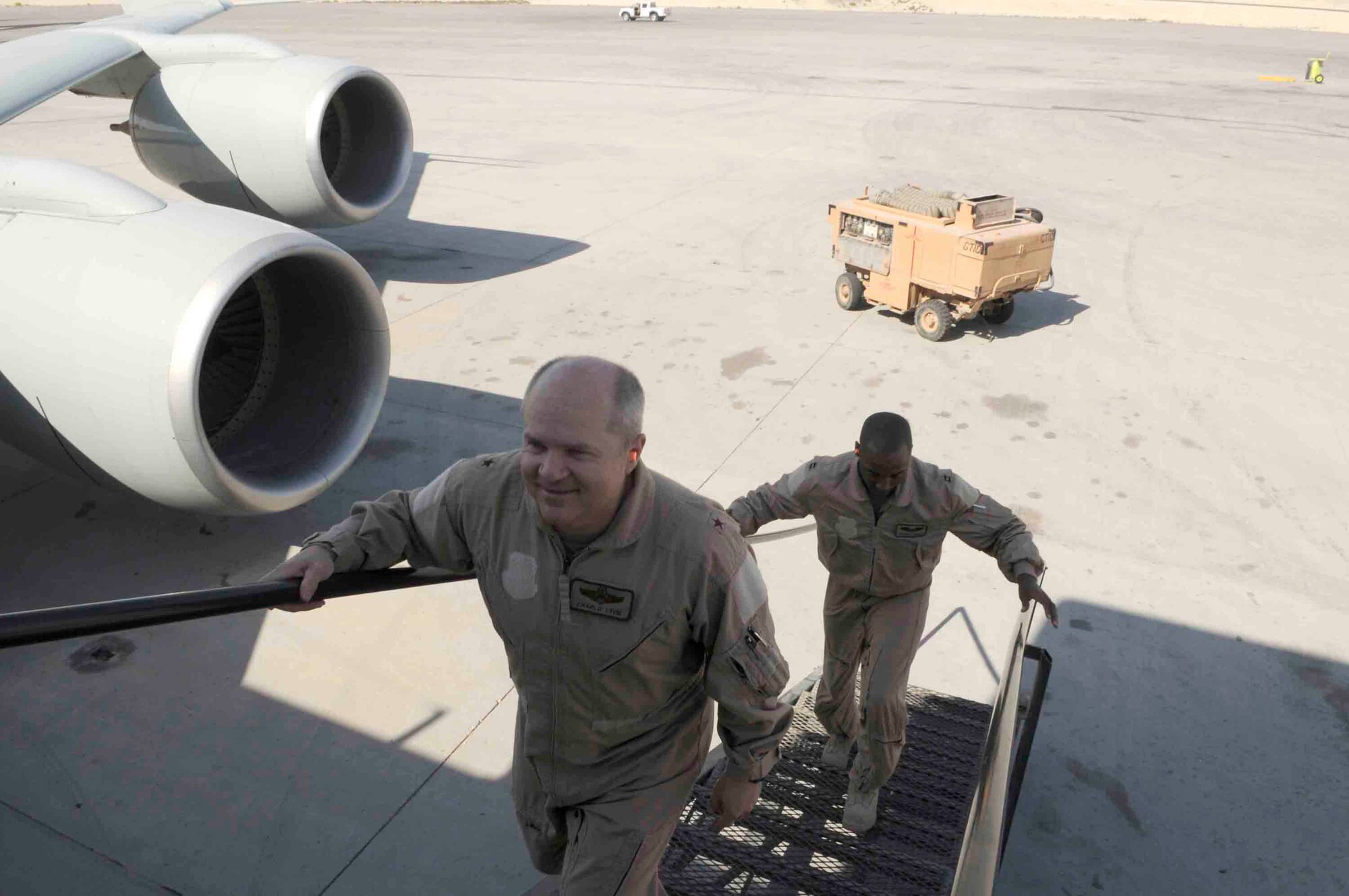 Brig. Gen. Charles W. Lyon boards an aircraft March 12 at a Southwest Asia air base. The general and Capt. Kareem Haskett of the 379th Expeditionary Reconnaissance Squadron piloted an RC-135 Rivet Joint that logged 50,000 hours flight time. General Lyon is the 379th Air Expeditionary Wing commander. (U.S. Air Force photo/Tech. Sgt. Johnny L. Saldivar) 
