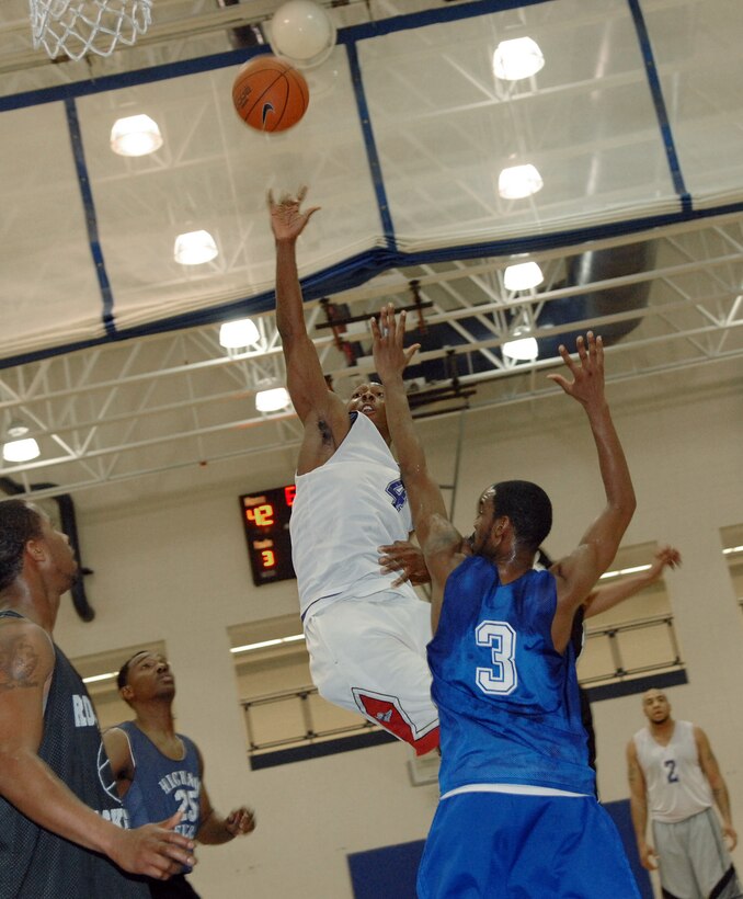 Omar Osgood, 1st Security Force Squadron, shoots the ball over 1st Medical Group defenders during the Langley Intramural Championship Game on March 7.   Osgood led all scorers with 16 points as the 1st SFS defeated the 1st MDG 49-39.  (U.S. Air Force photo/Senior Airman Vernon Young)