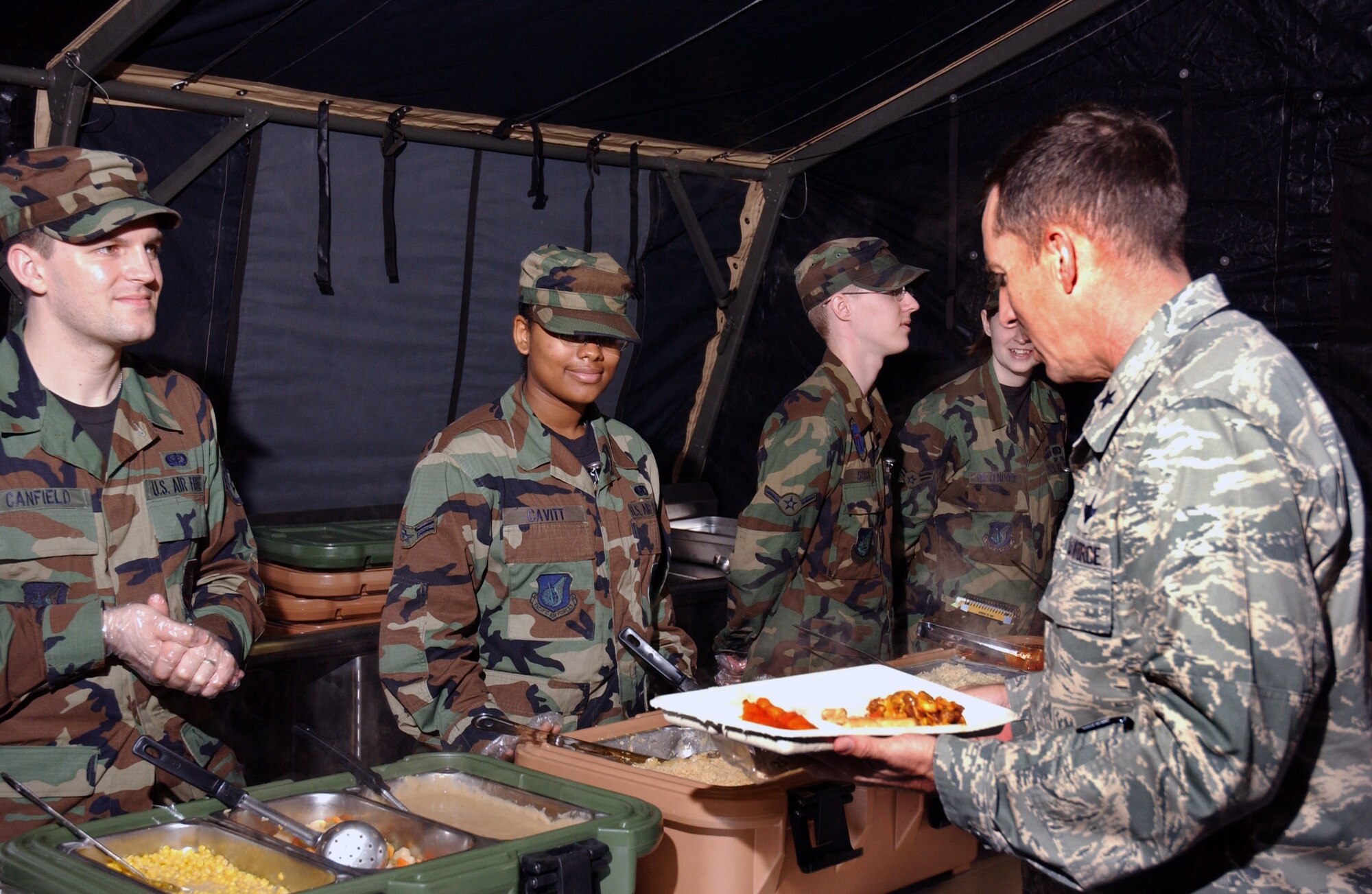 Brig. Gen. Brett Williams chooses from a variety of food offered by the 18th Services Squadron's single pallet expeditionary kitchen during the Pacific Air Forces Operational Readiness Inspection March 11at Kadena Air Base, Japan. The deployable kitchen can be set up from pallet to serving in under four hours. PACAF is conducting the inspection from March 9 to 15 to validate the mission readiness of the 18th Wing. General Williams is the 18th Wing commander. (U.S. Air Force photo/Senior Airman Jeremy McGuffin) 