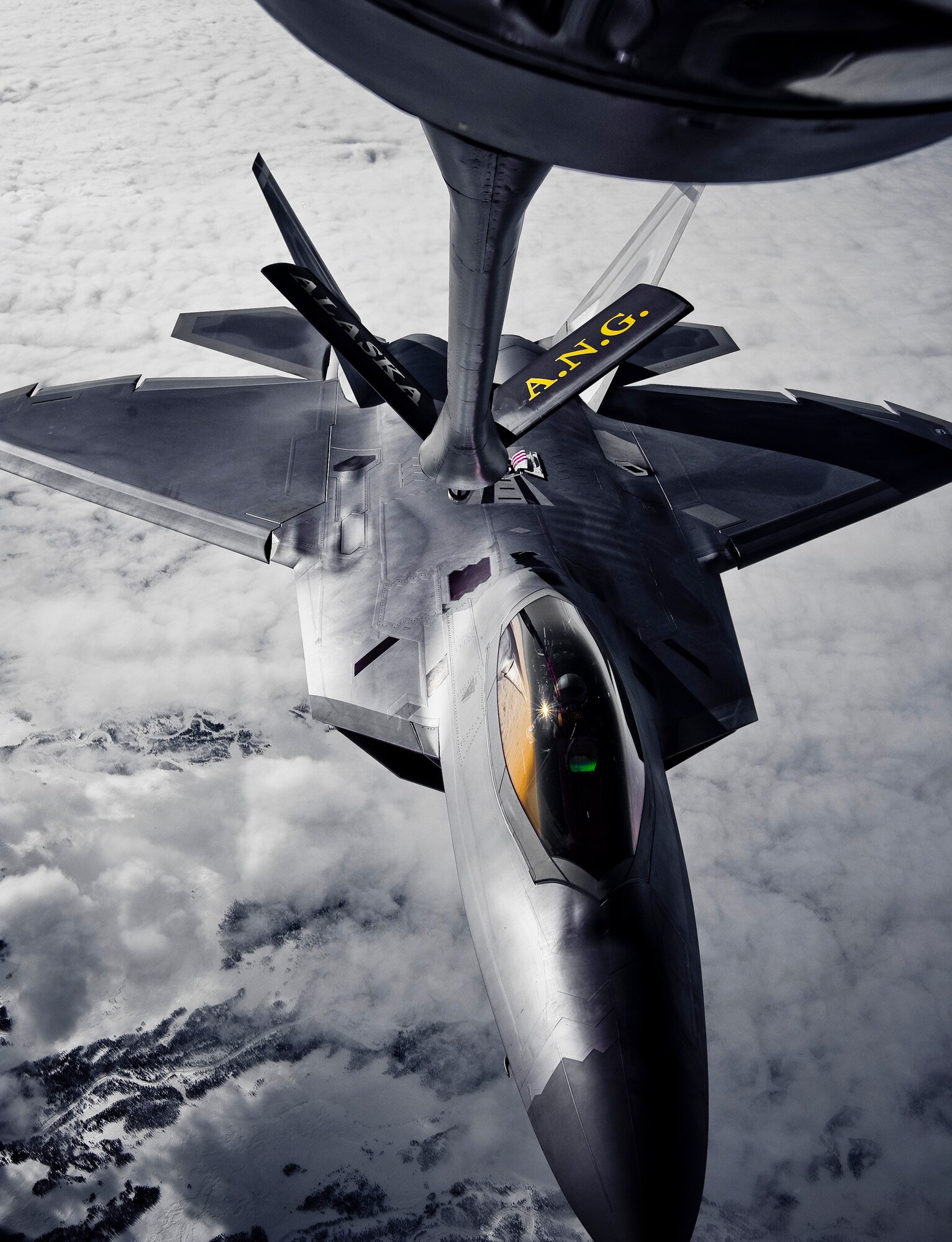 OVER ALASKA -- A KC-135 Stratotanker from the Alaska Air National Guard 168th Air Refueling Wing refuels an F-22 Raptor from the 90th Fighter Squadron at Elmendorf Air Force Base fly in for refueling. With the KC-135's mission of air refueling, the F-22 capabilities can accomplish its mission of global engagement. (U.S. Air Force photo by Airman 1st Class Jonathan Steffen)