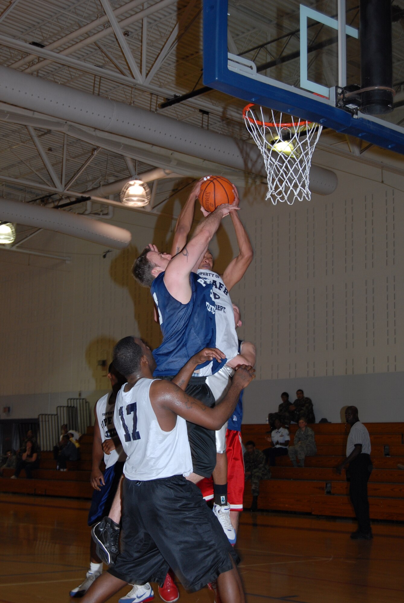 Kenneth Carter, 43rd Logistics Readiness Squadron, grabs one of his six rebounds over Kasey Crews, 43rd Mission Support Squadron, during 43rd LRS Pope Intramural Basketball championship game win Mar. 3. Carter's six rebounds were a game high and key to 43rd LRS' 55-43 victory. (U.S. Air Force Photo/2nd Lt. Chris Hoyler)