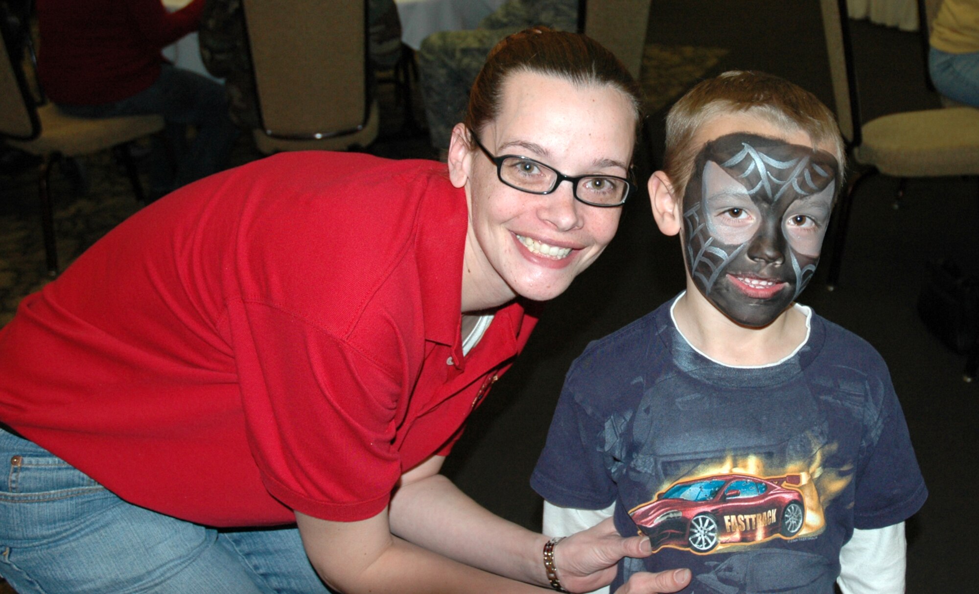 Tech. Sgt. Jennifer Lyon, Airman & Family Readiness Center, poses with her son, Payton, 5, who just got his face painted at the Welcome Home Carnival March 12 at Club Hill.