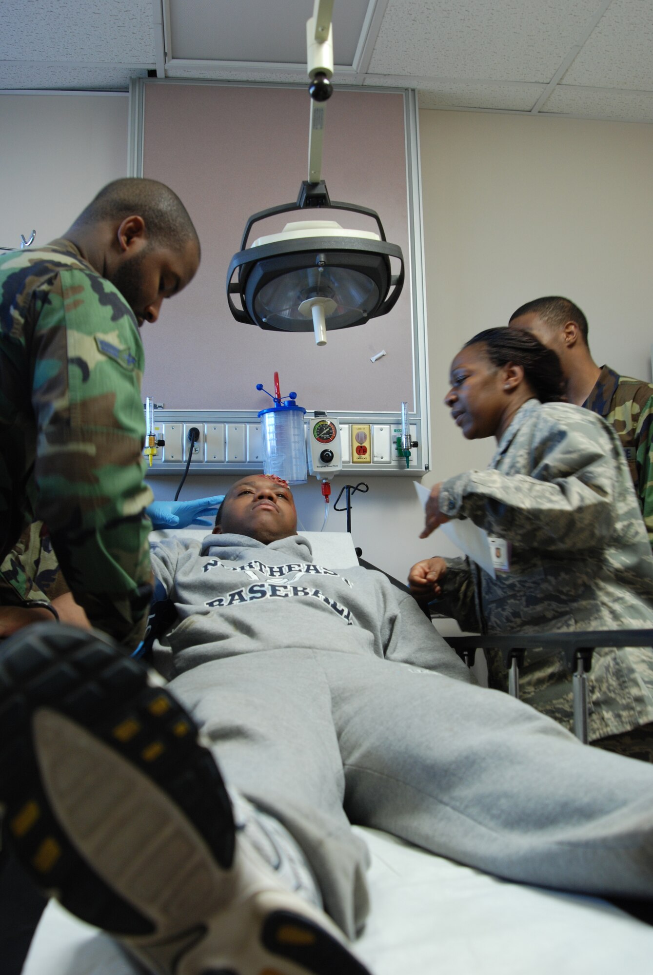 MCCONNELL AIR FORCE BASE, Kan. -- 22nd Medical Group professionals care for a simulated head wound on an "injured patient", March 11, during a base wide tornado response exercise. (Photo by Airman 1st Class Jessica Lockoski)