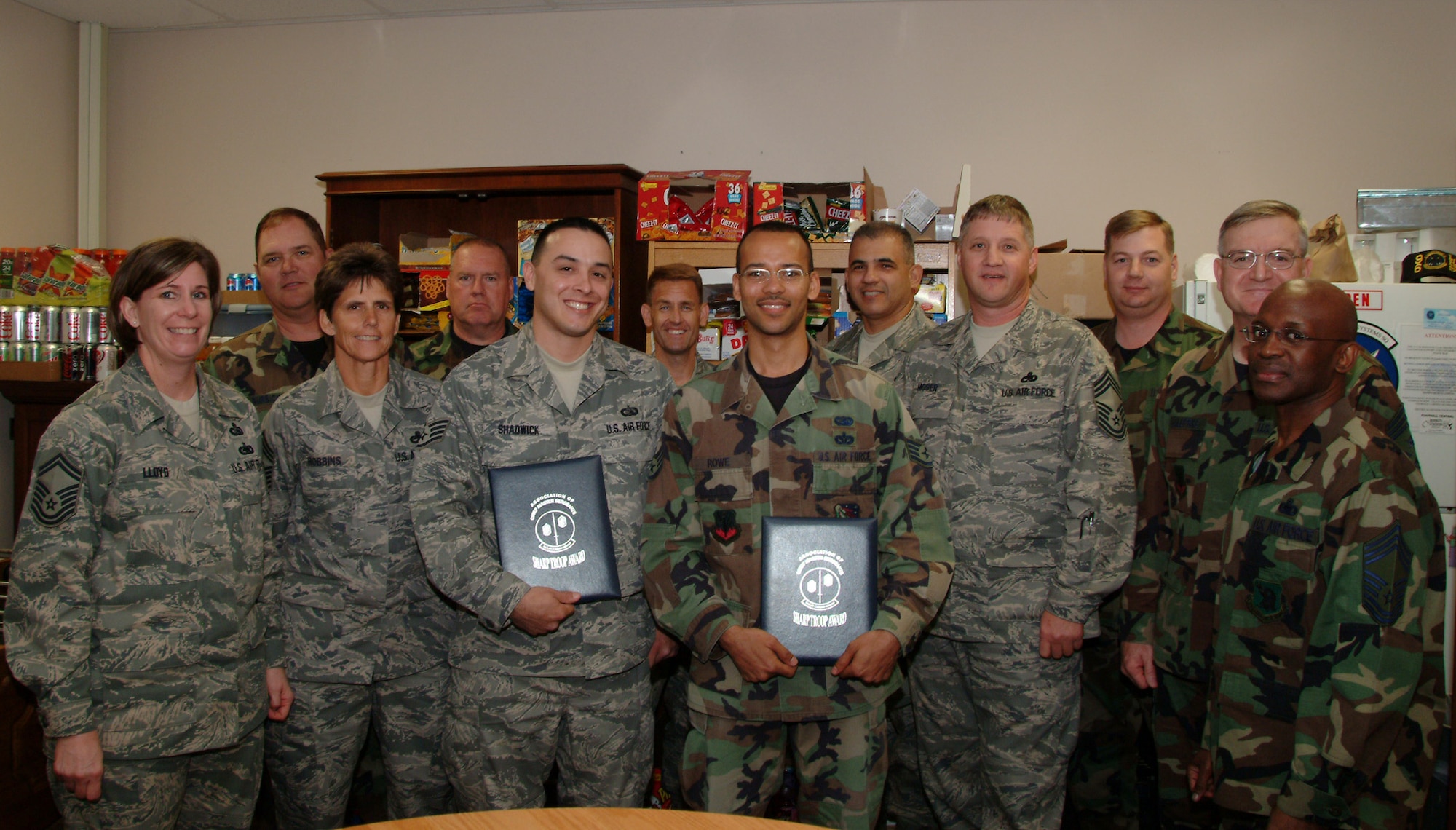 Staff Sgt.s Matthew Shadwick and Elvan Rowe, 53d Computer Systems Squadron, stand with members of Eglin Air Force Base's Chief's Group after being chosen for the Sharp Troop Award March 13. The Chief's Group selects 53 "sharp troops" annually.  The 53d Wing has had three so far this year. Air Force photo by Staff Sgt. Samuel King Jr. 