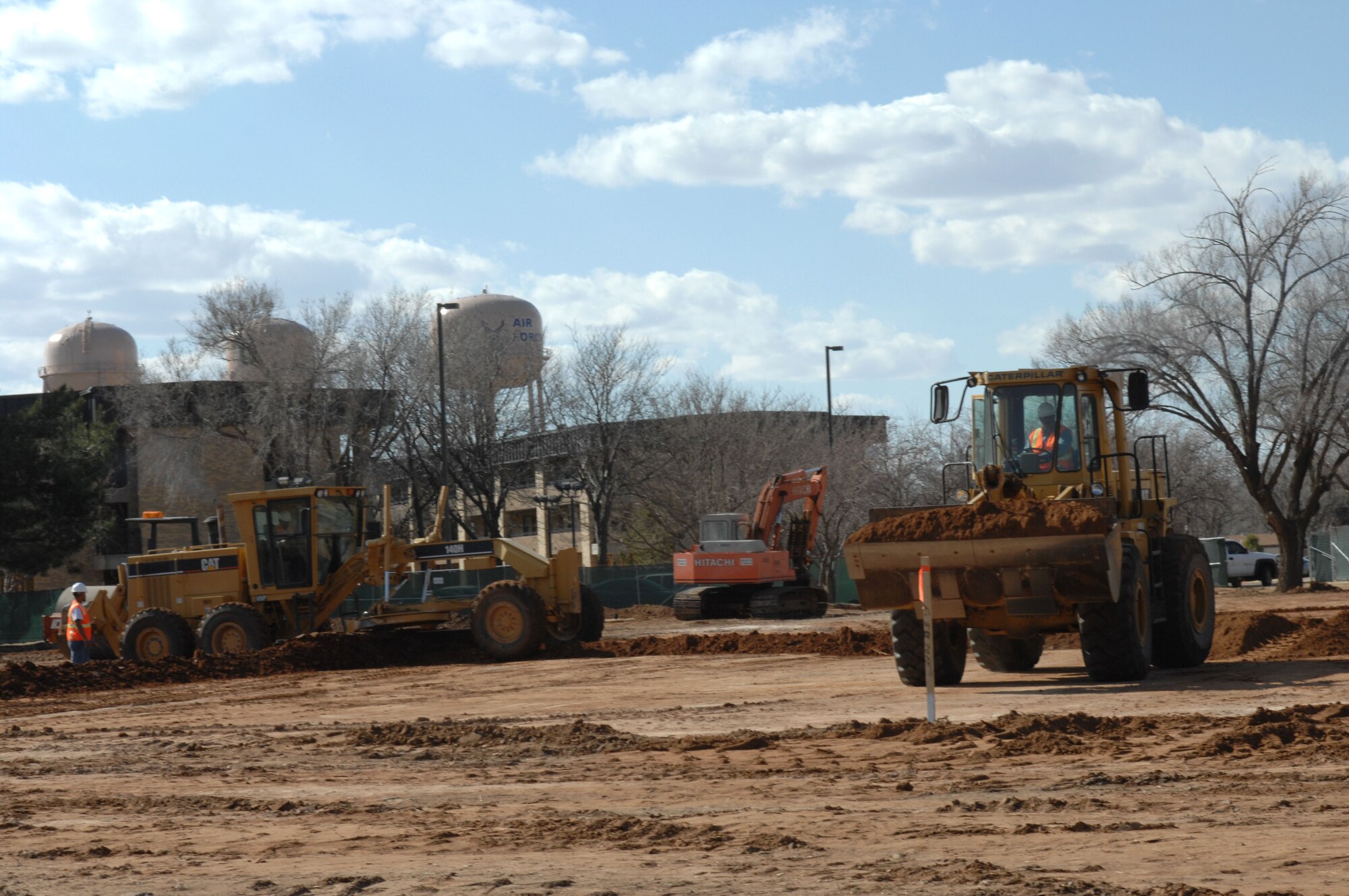 CANNON AIR FORCE BASE, N.M. -Contractors smooth out terrain on Arcadia Ave. March 11 to make way for the construction of a new dining facility/Airmen's center. The old post office and Dorm 1247 are currently being demolished to make way for the new facility and its parking lot. (U.S. Air Force photo by Airman 1st Class James Bell)
