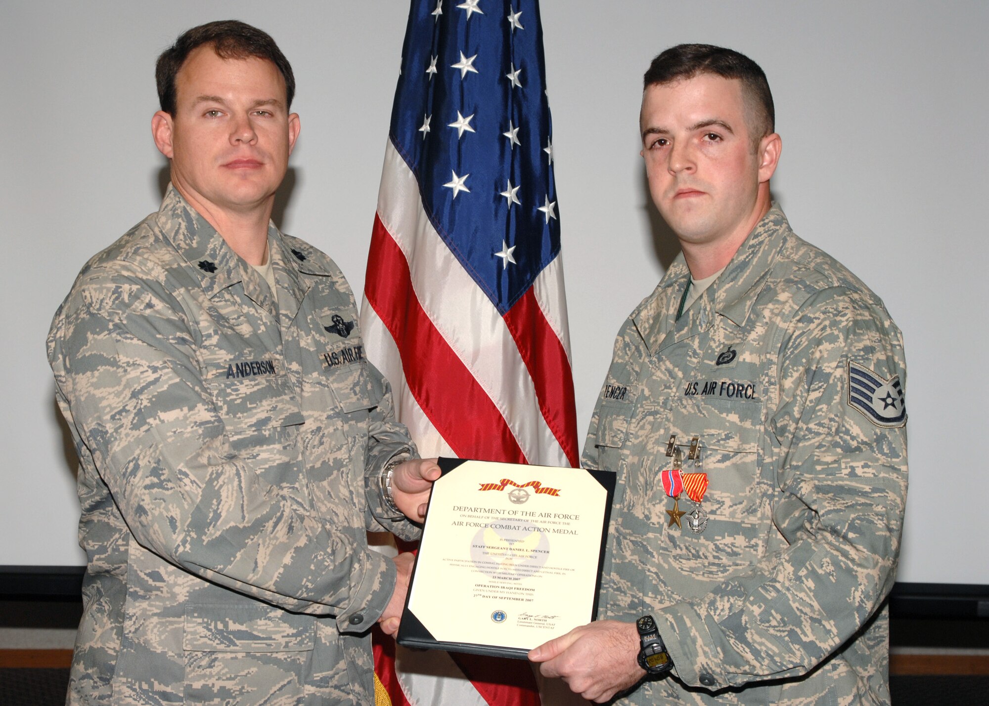 Lieutenant Colonel Byron Anderson presents Staff Sergeant Daniel Spencer with a Bronze Star and Air Force Combat Action Metal at Seymour Johnson AFB, North Carolina on March 12, 2008.  Staff Sergeant Spencer distinguished himself on a 365 day rotation to South West Asia.

(US Air Force photo by Airman First Class Salma Din)(Released)
